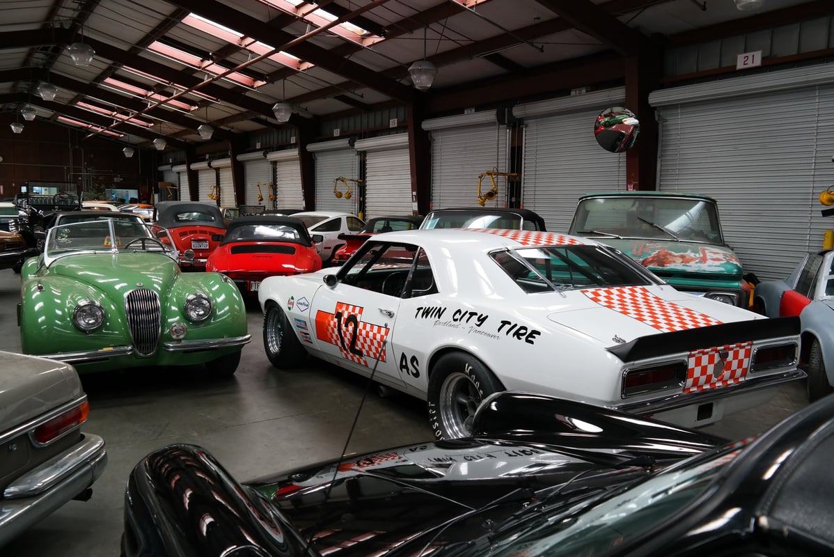 Classic cars staged for loading at an international vehicle shipping warehouse