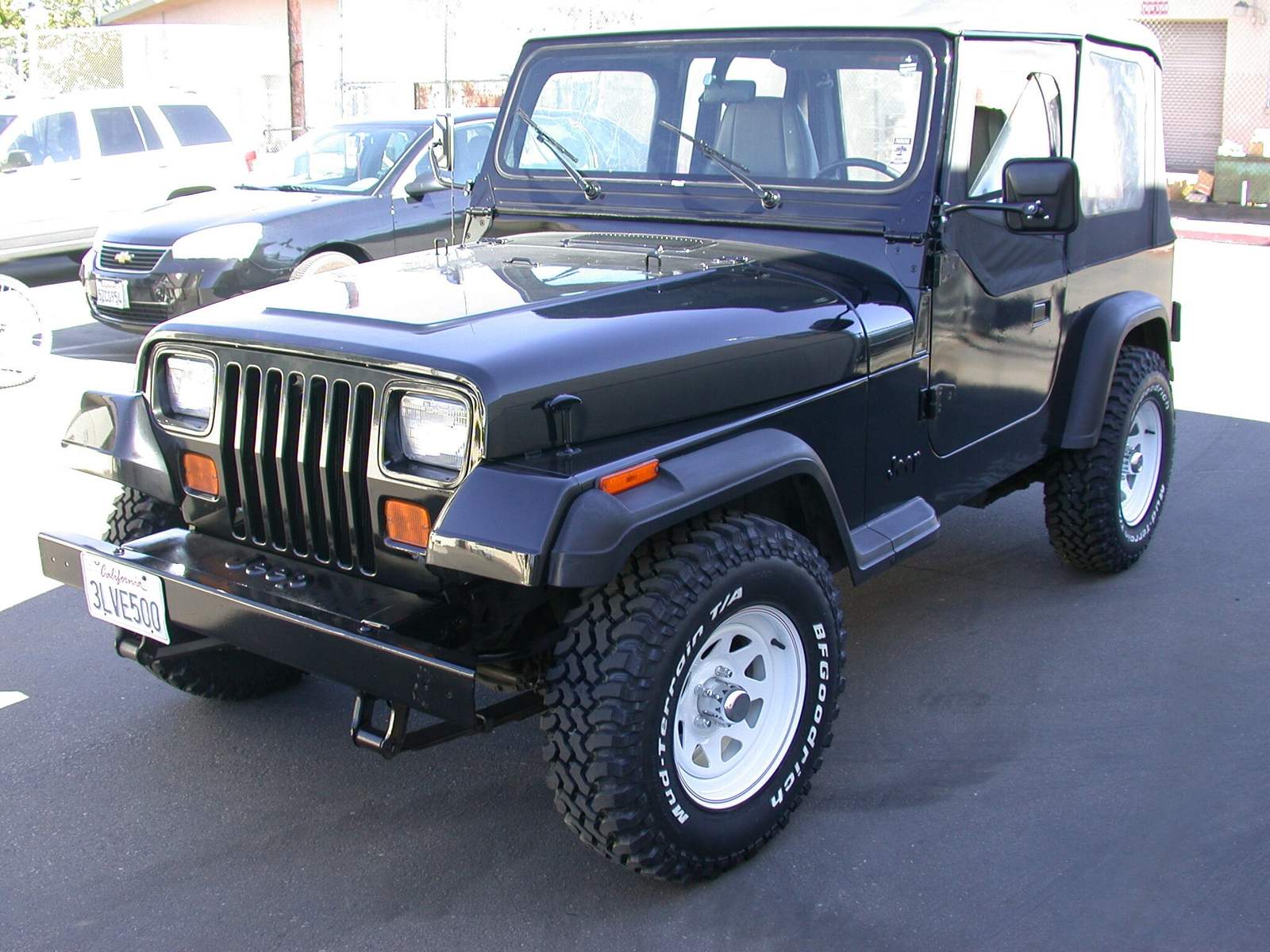 Jeep Wrangler YJ parked outside a workshop
