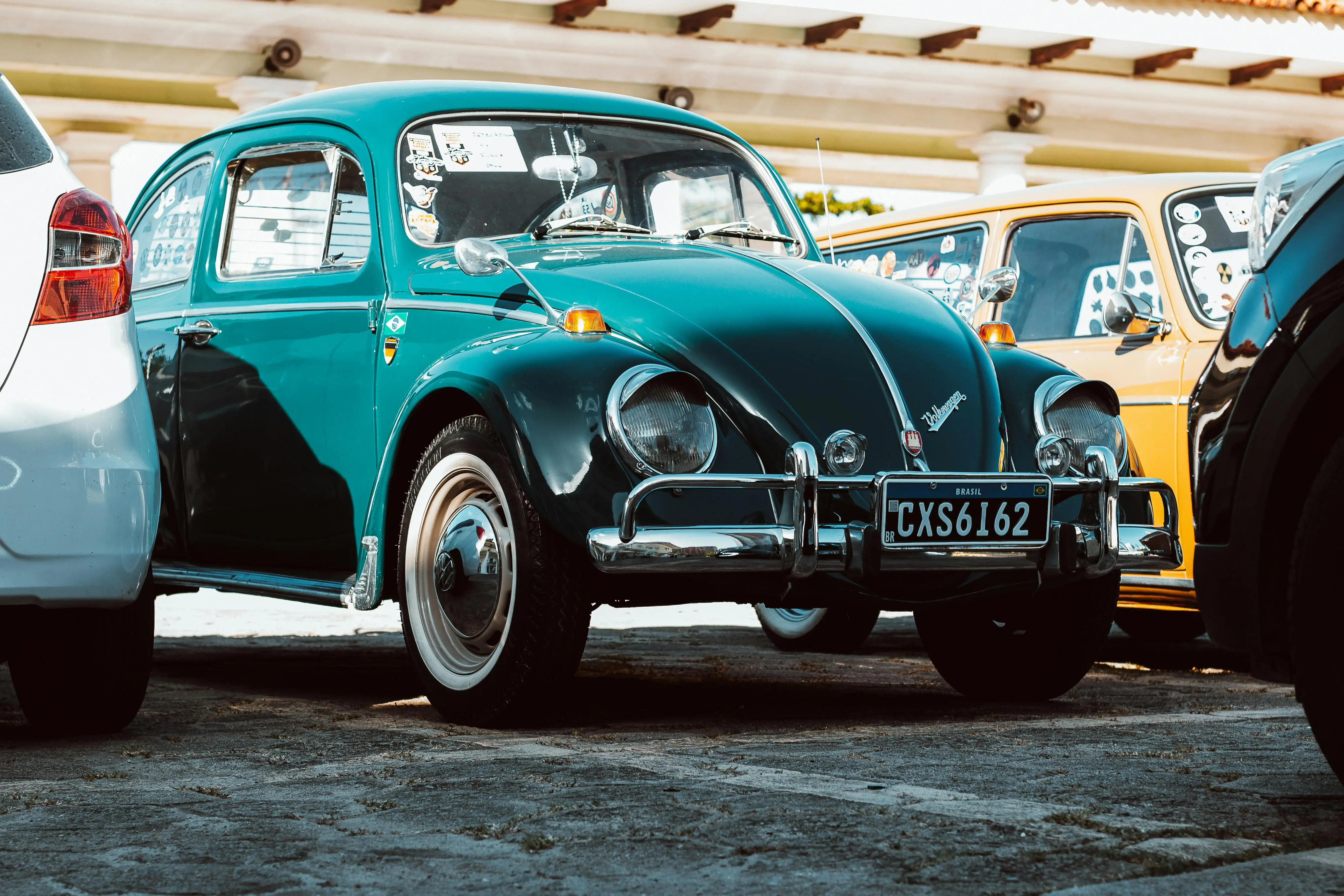  a classic green Volkswagen Beetle parked outdoors 