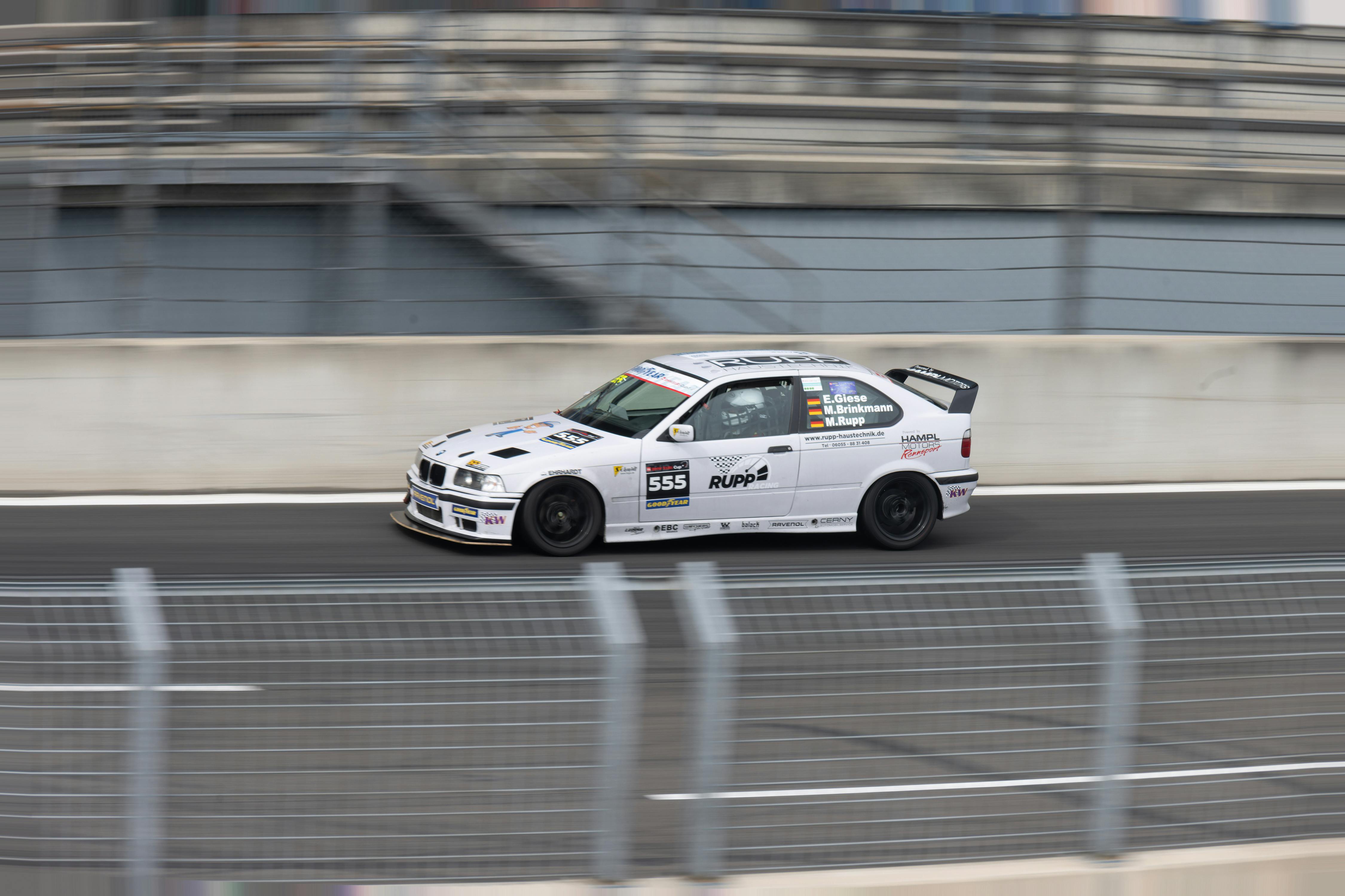 High-speed racing car on track in motion