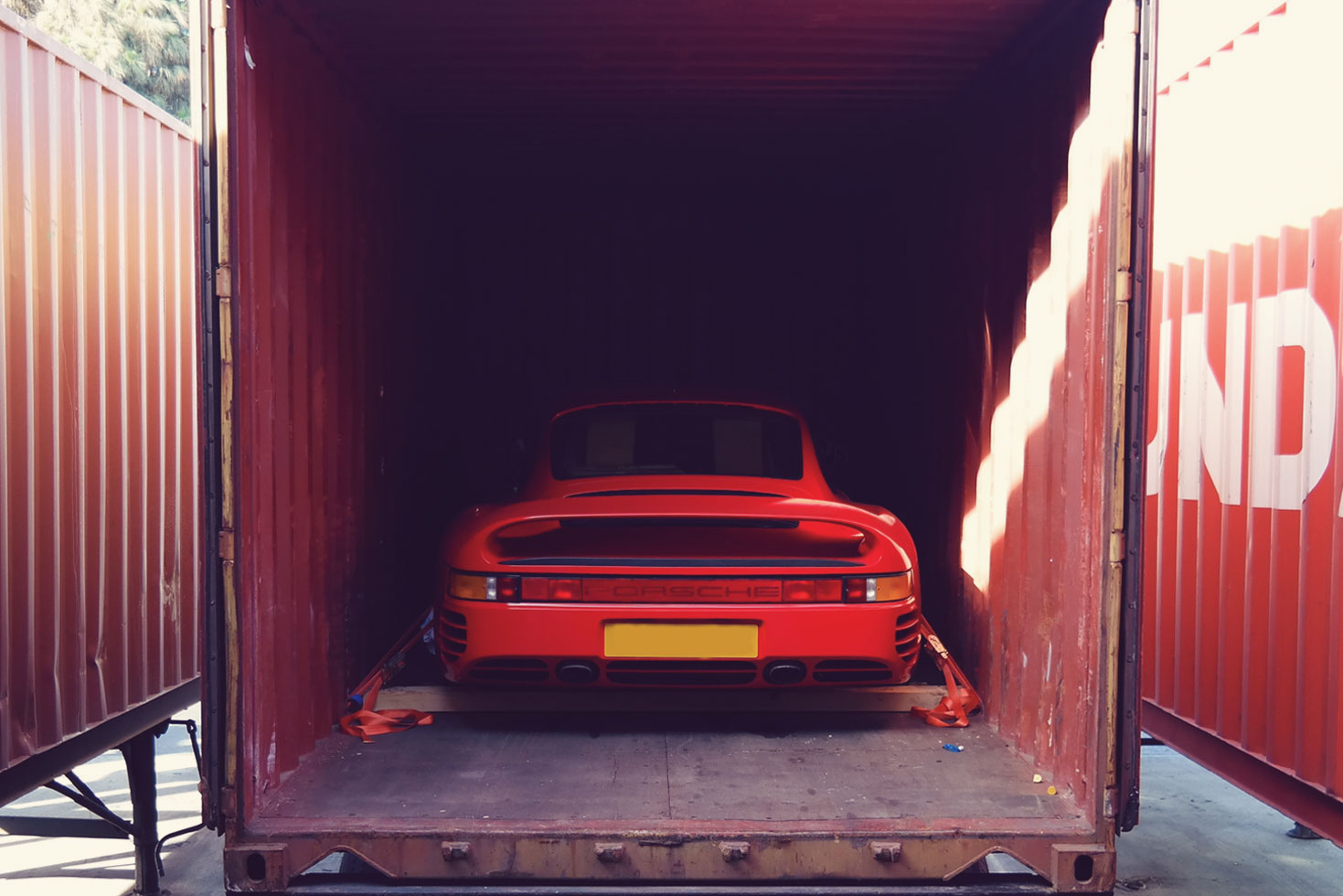 porsche 959 inside of a shipping container