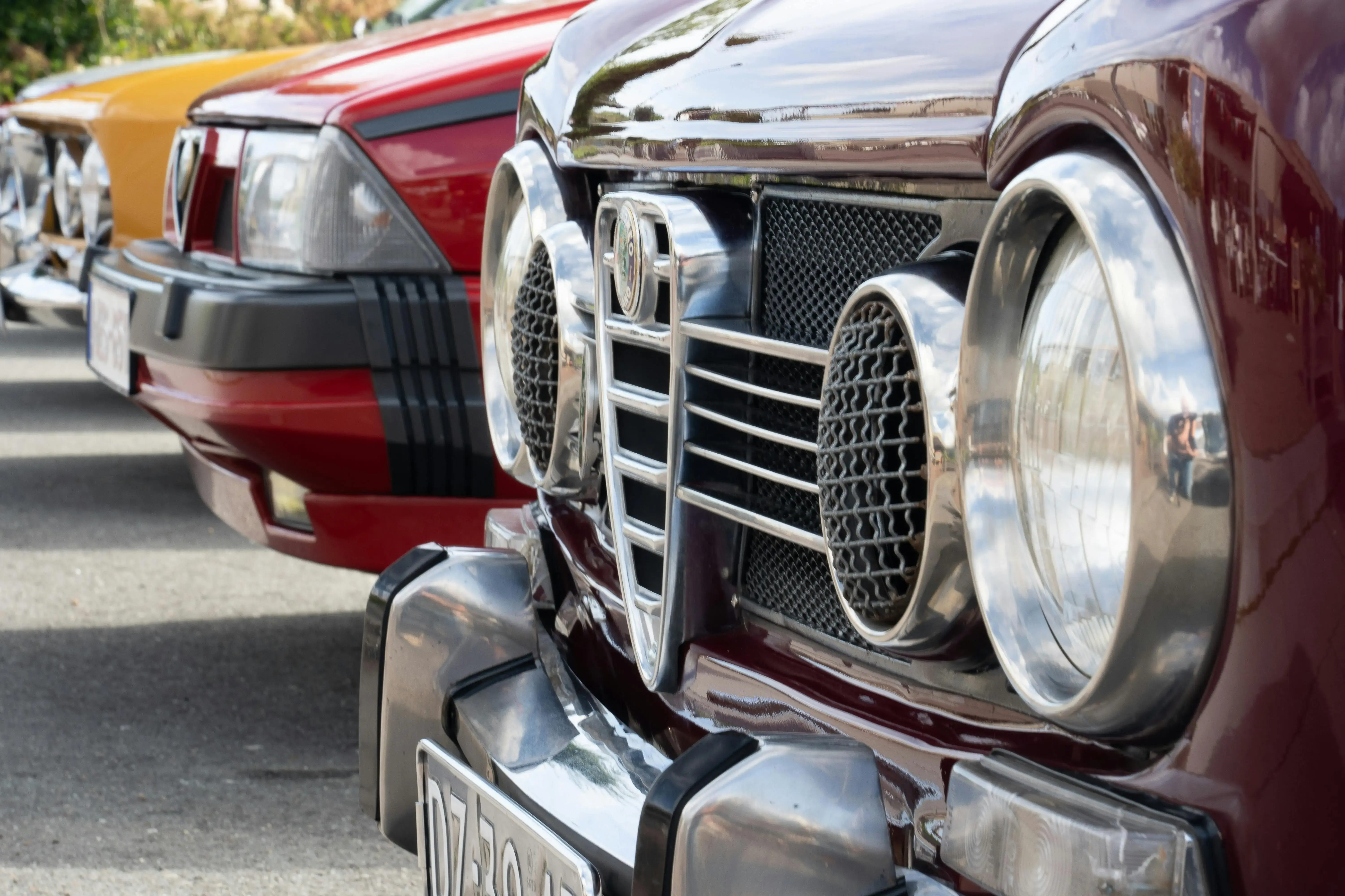 A row of classic cars lined up outdoors