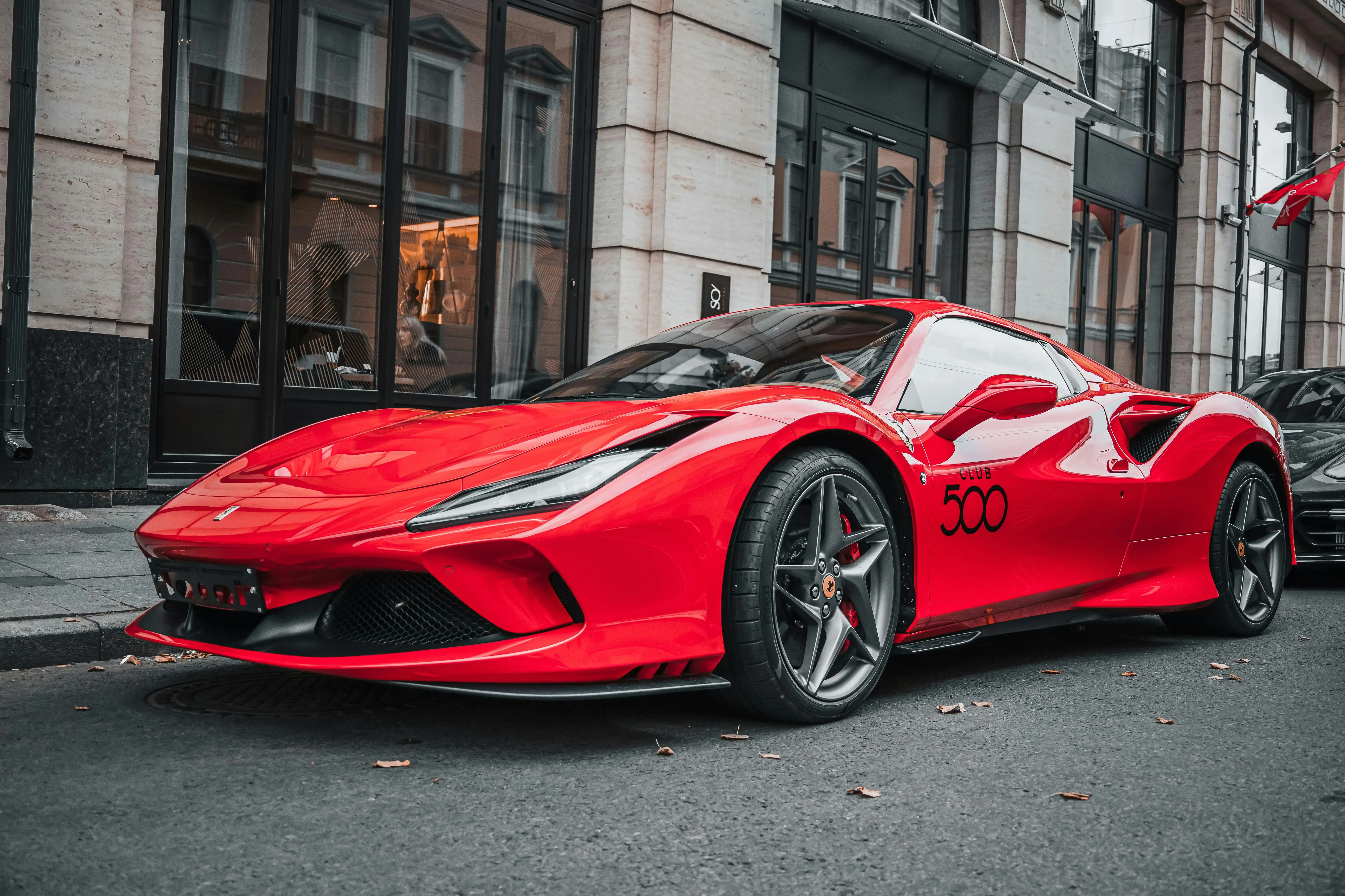 A Red Ferrari Car Parked on the Street