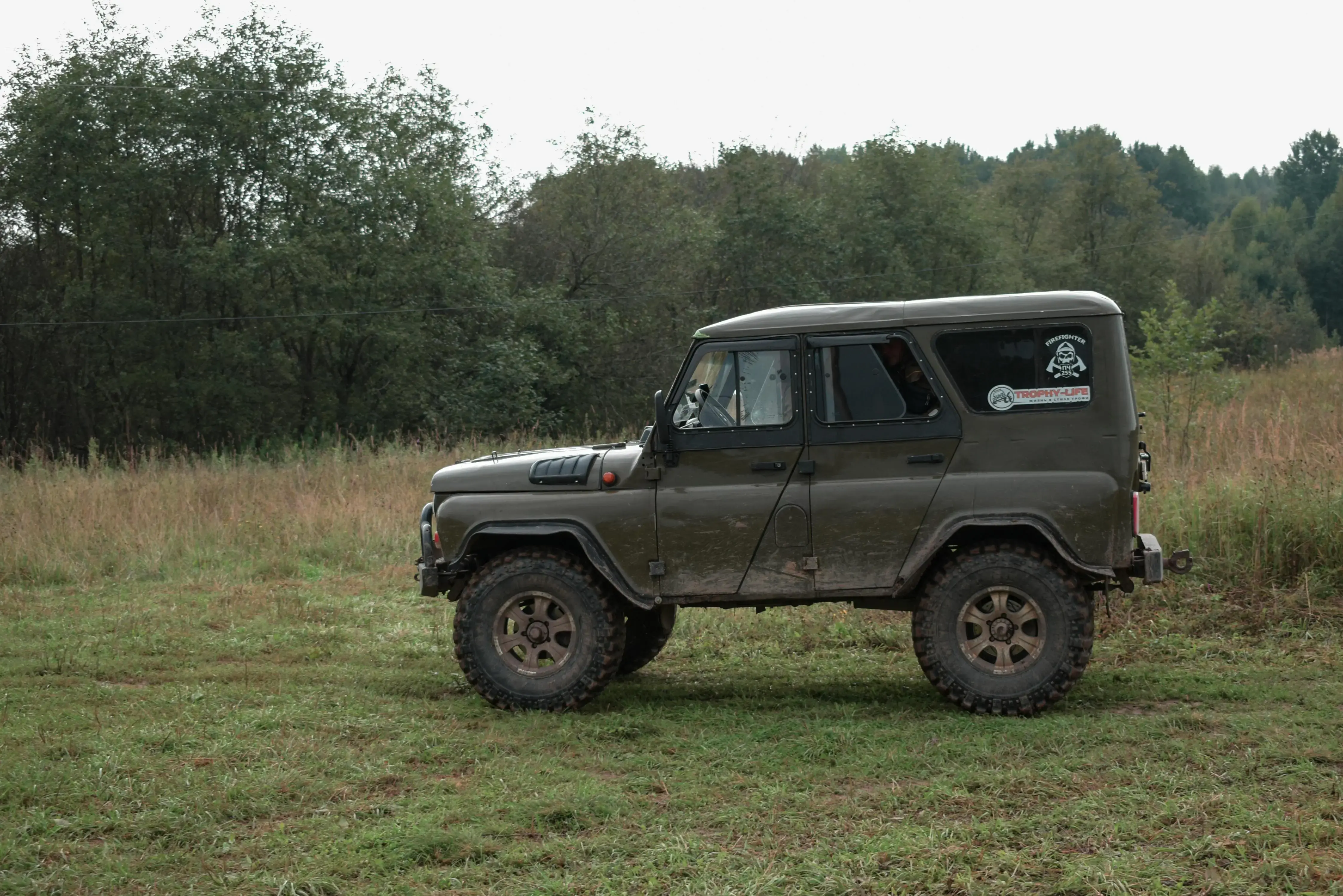 A dark olive green military-style 4x4