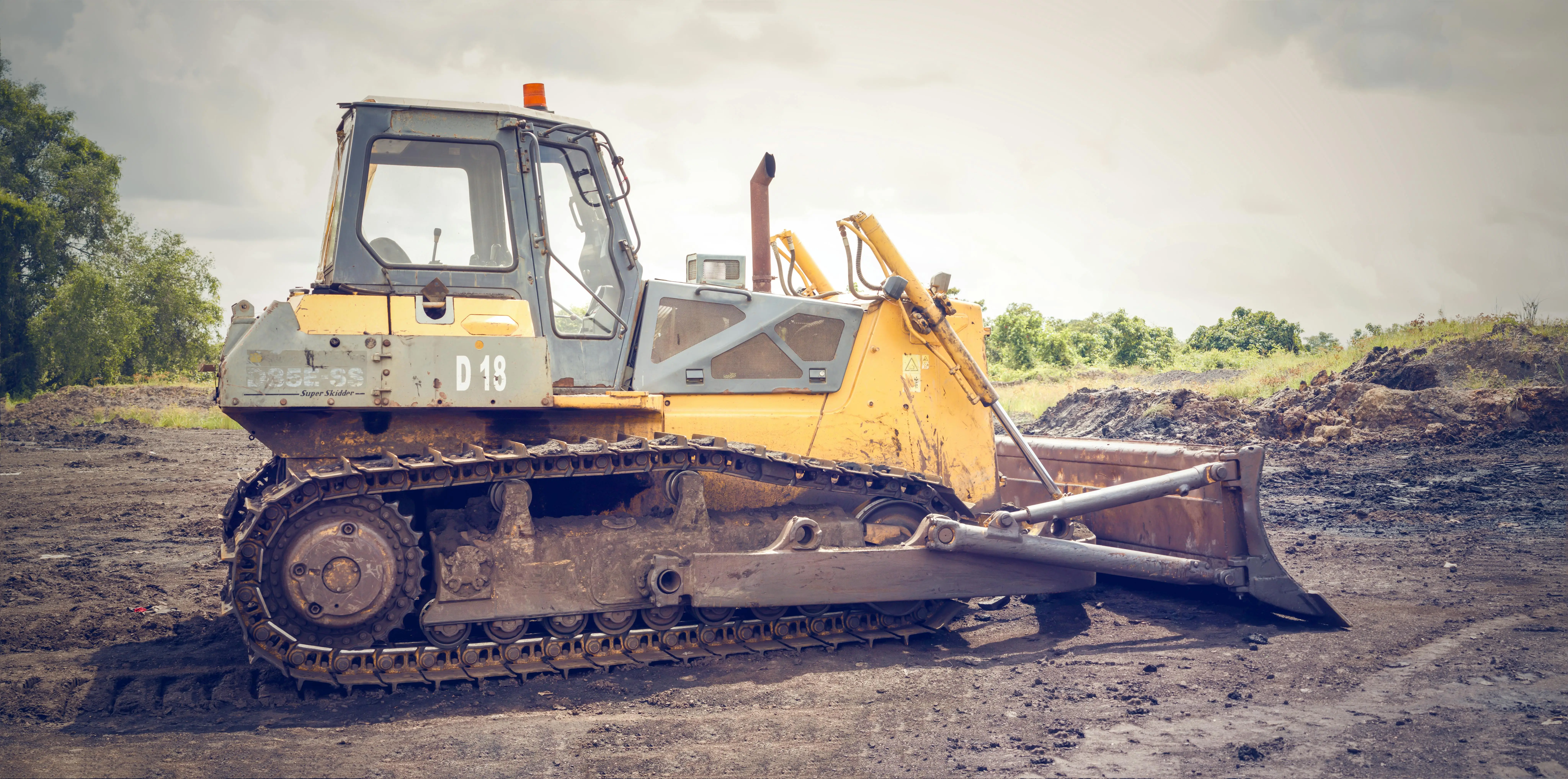 Yellow and Brown Metal Pay Loader on the Dirt