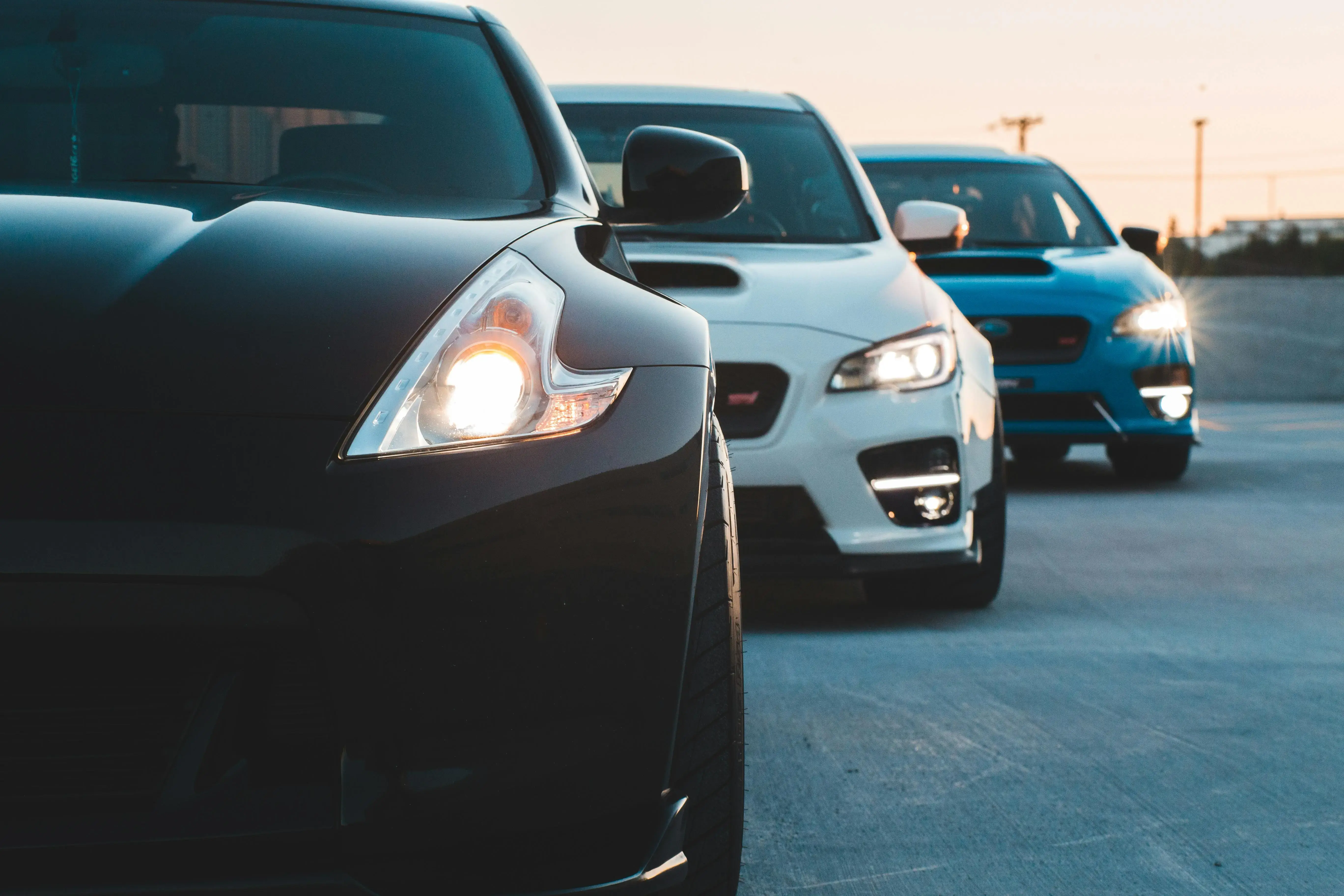 Headlights of cars parked in row in evening