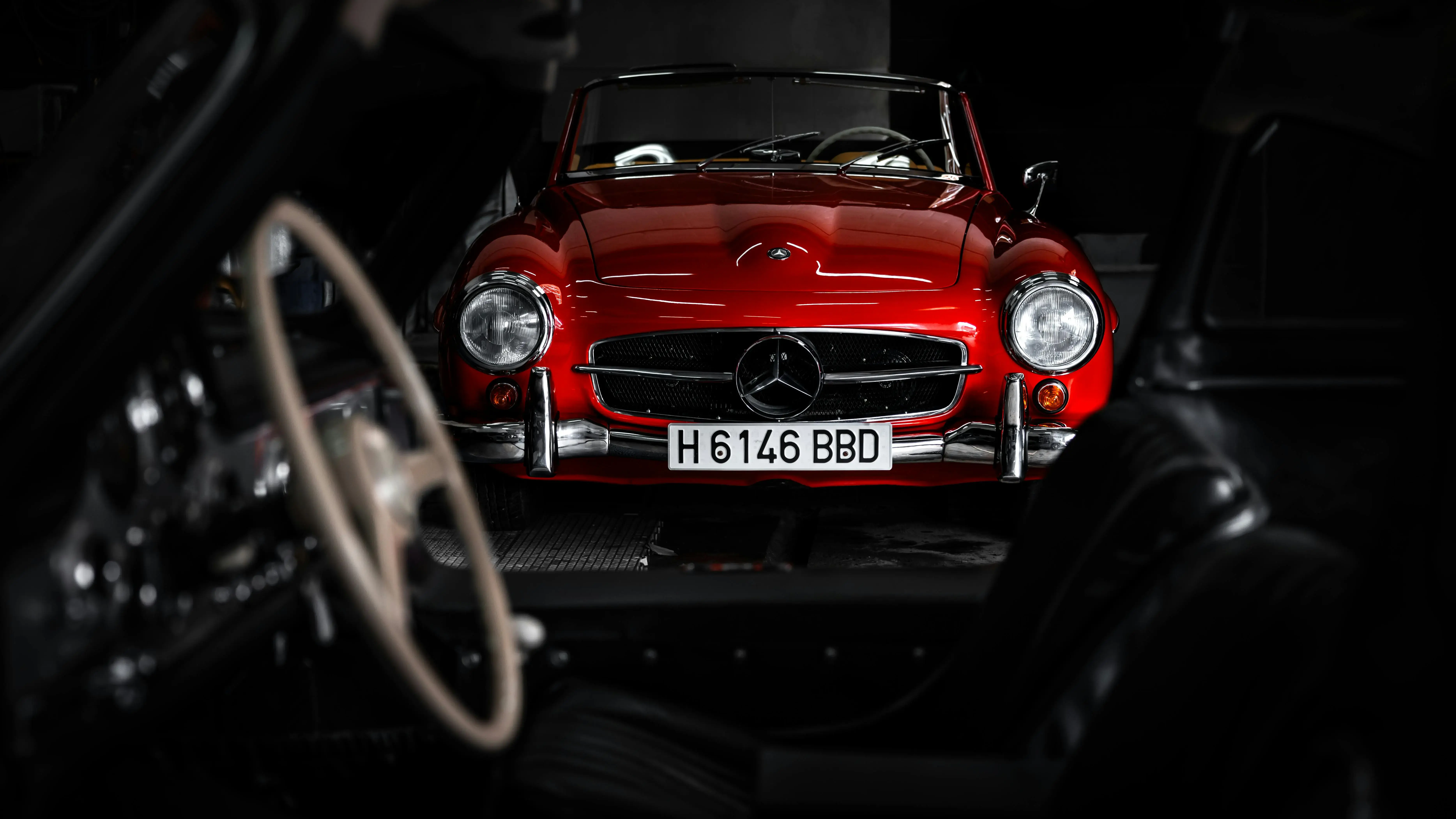 Red Classic Car in Dark Garage Setting