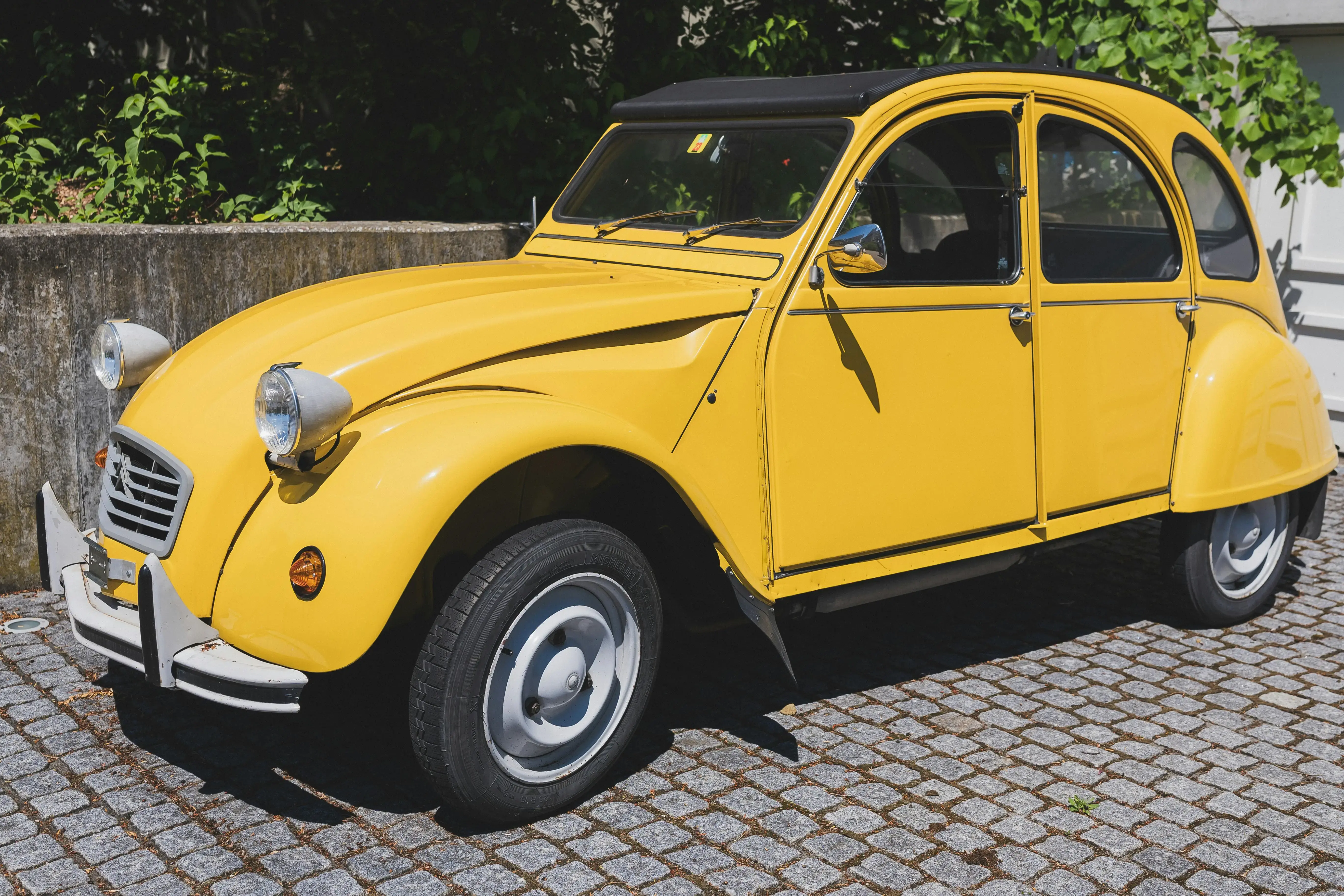 Vintage Yellow Citroën Car in Sunlit Swiss Street
