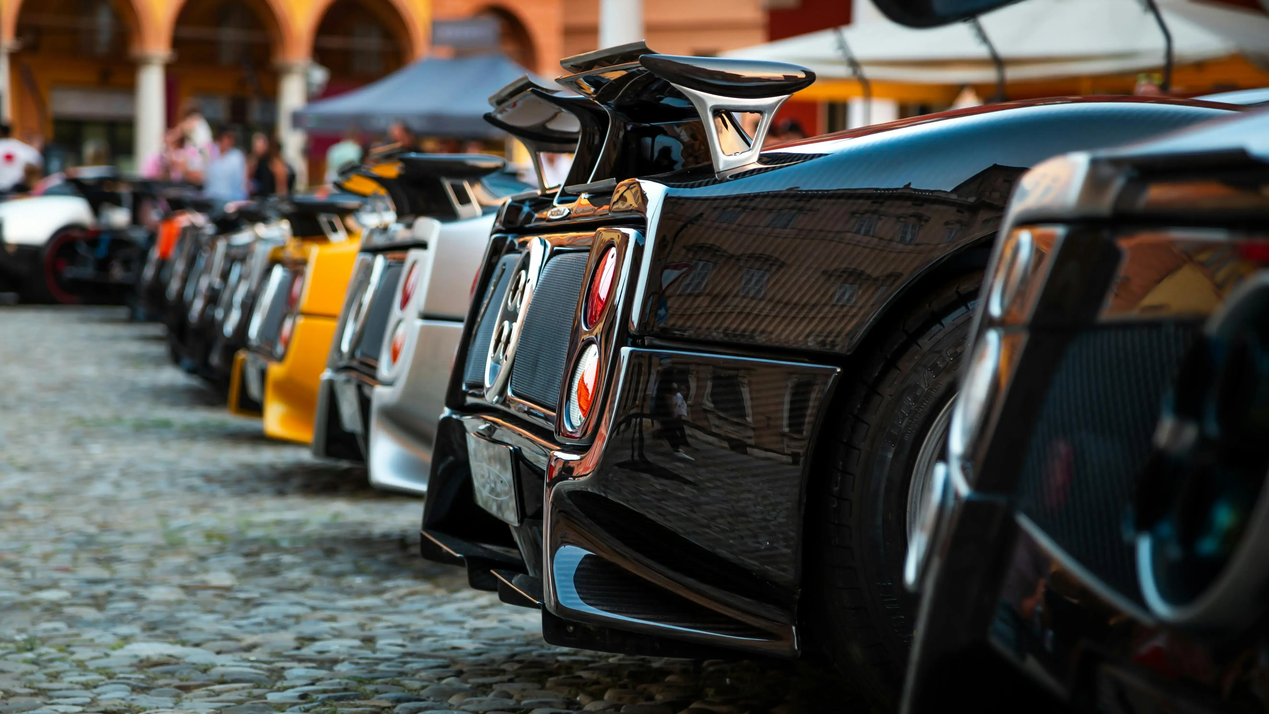 Lineup of Luxurious Supercars at Outdoor Exhibition