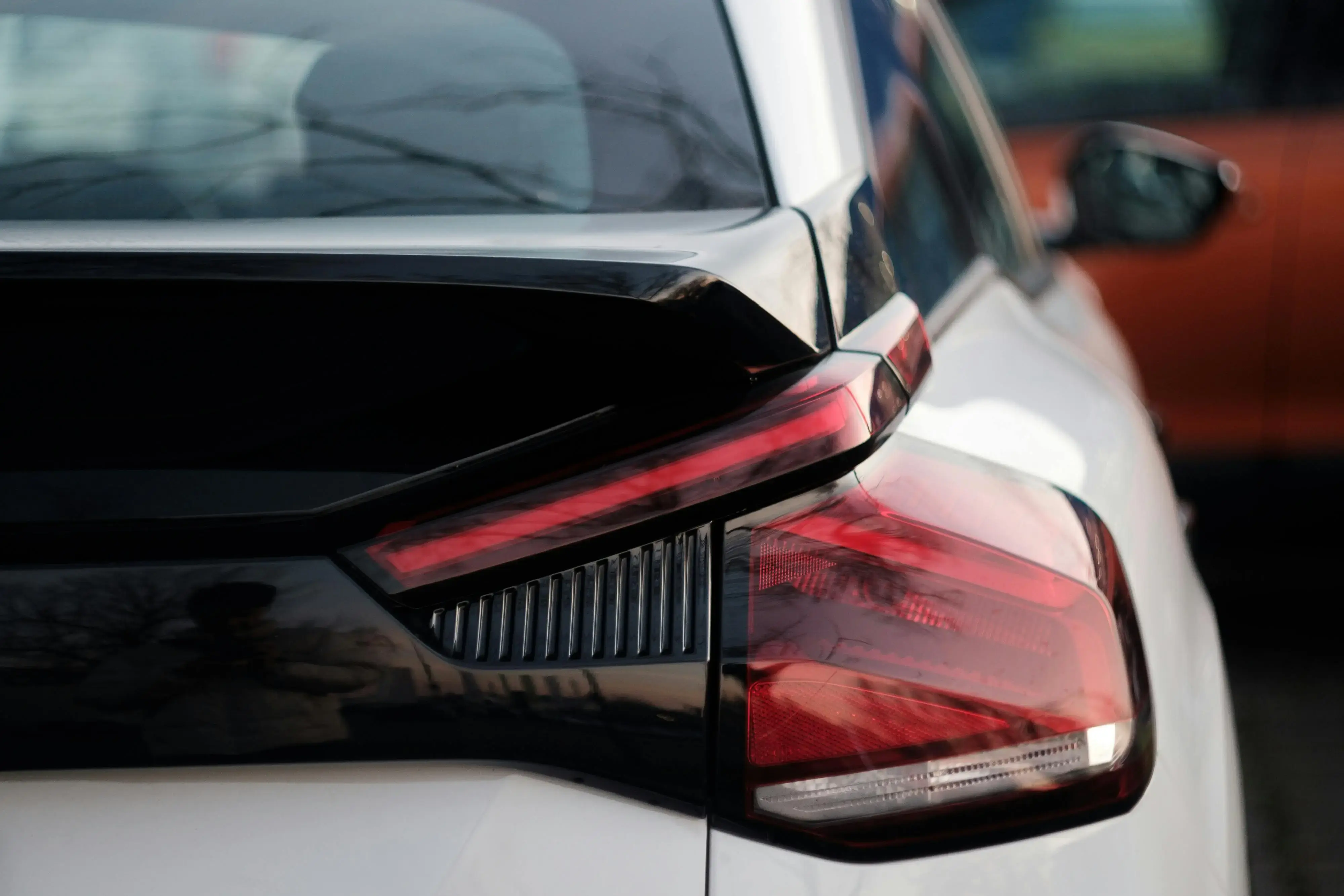 Modern Car Tail Light Close-Up in Urban Setting