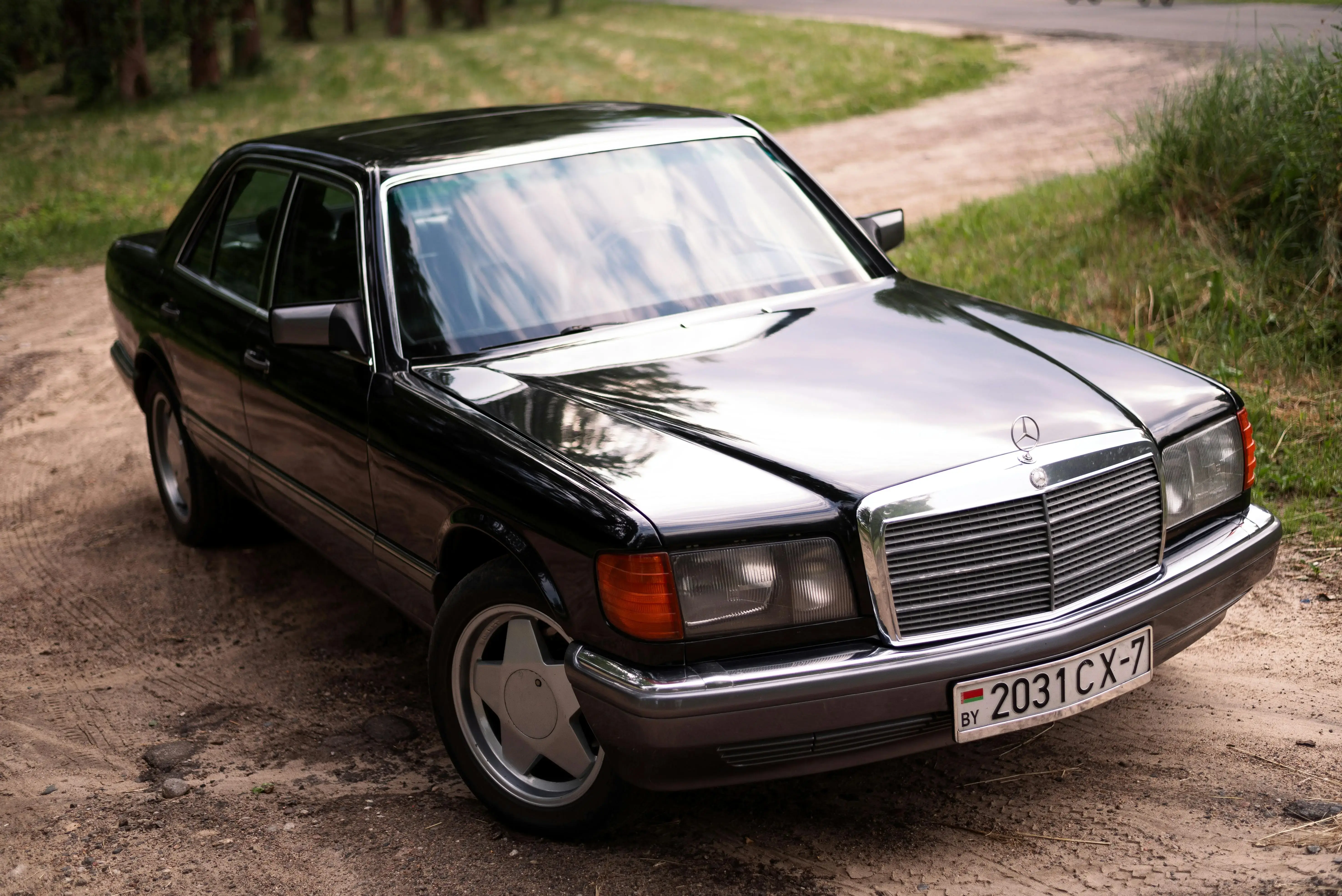 Black Mercedes W126 on Dirt Road