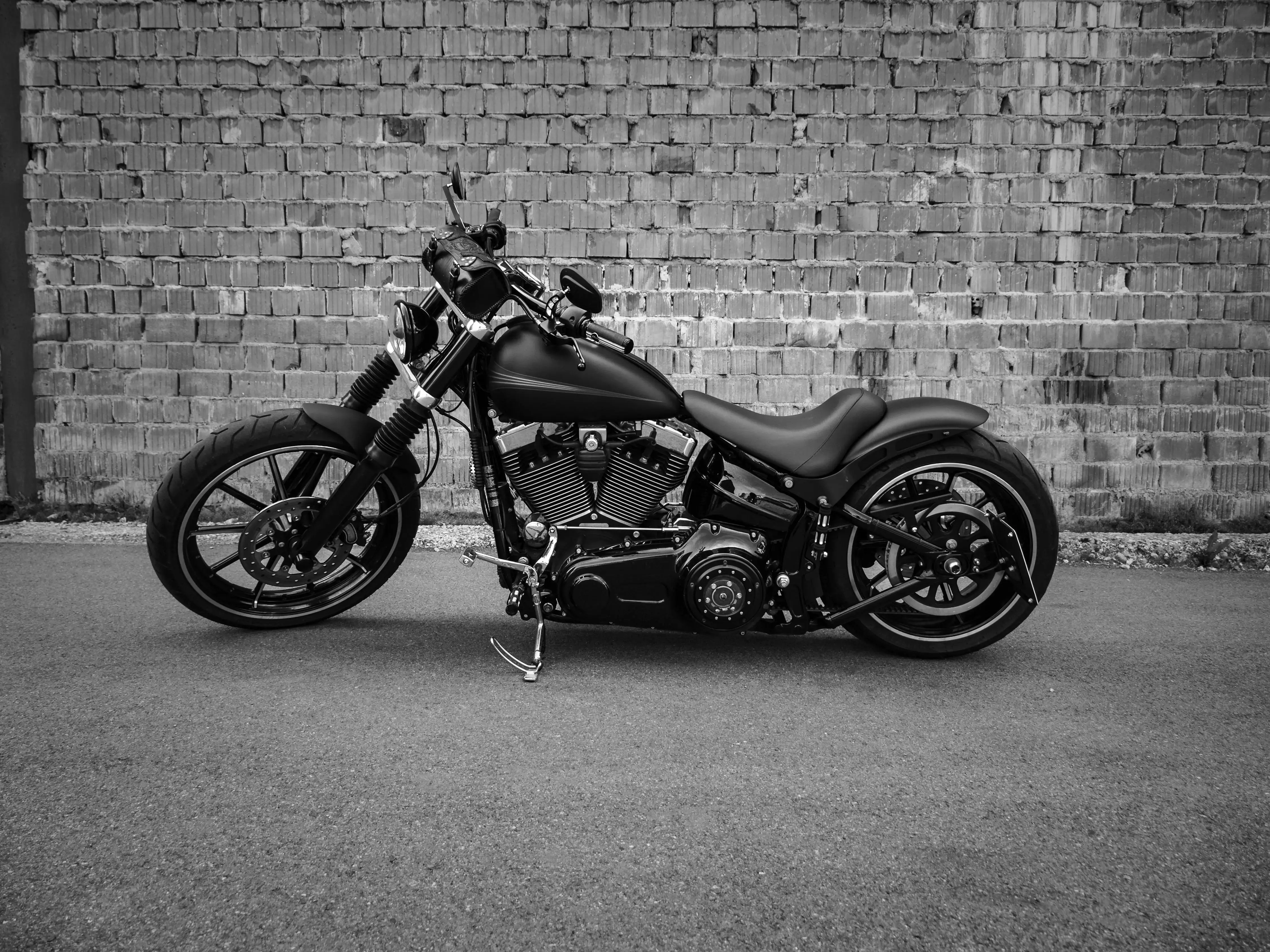 Grayscale Photo of a Cruiser Motorcycle Parked on the Road