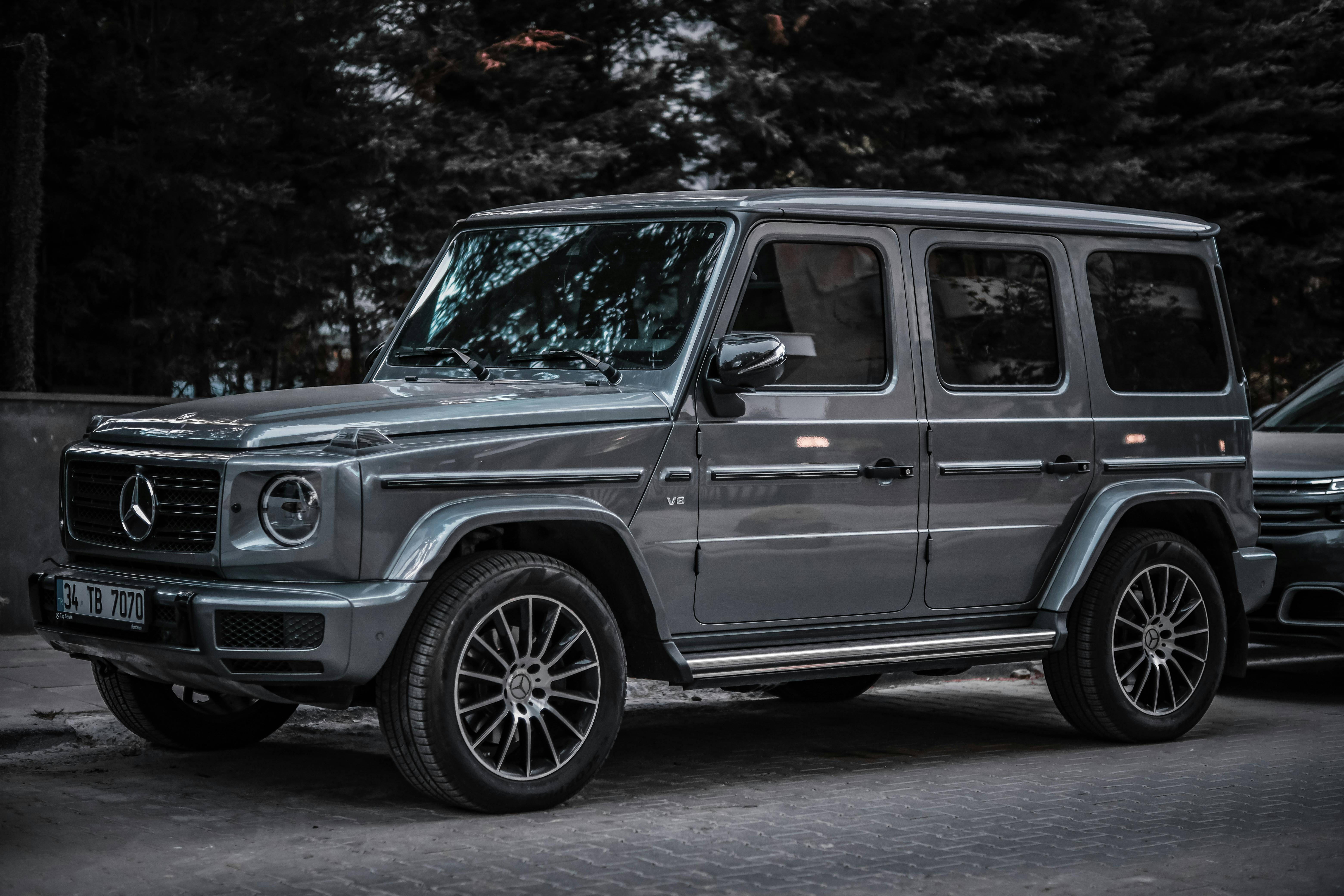 Mercedes-Benz G-Class with German registration parked on a tree-lined road