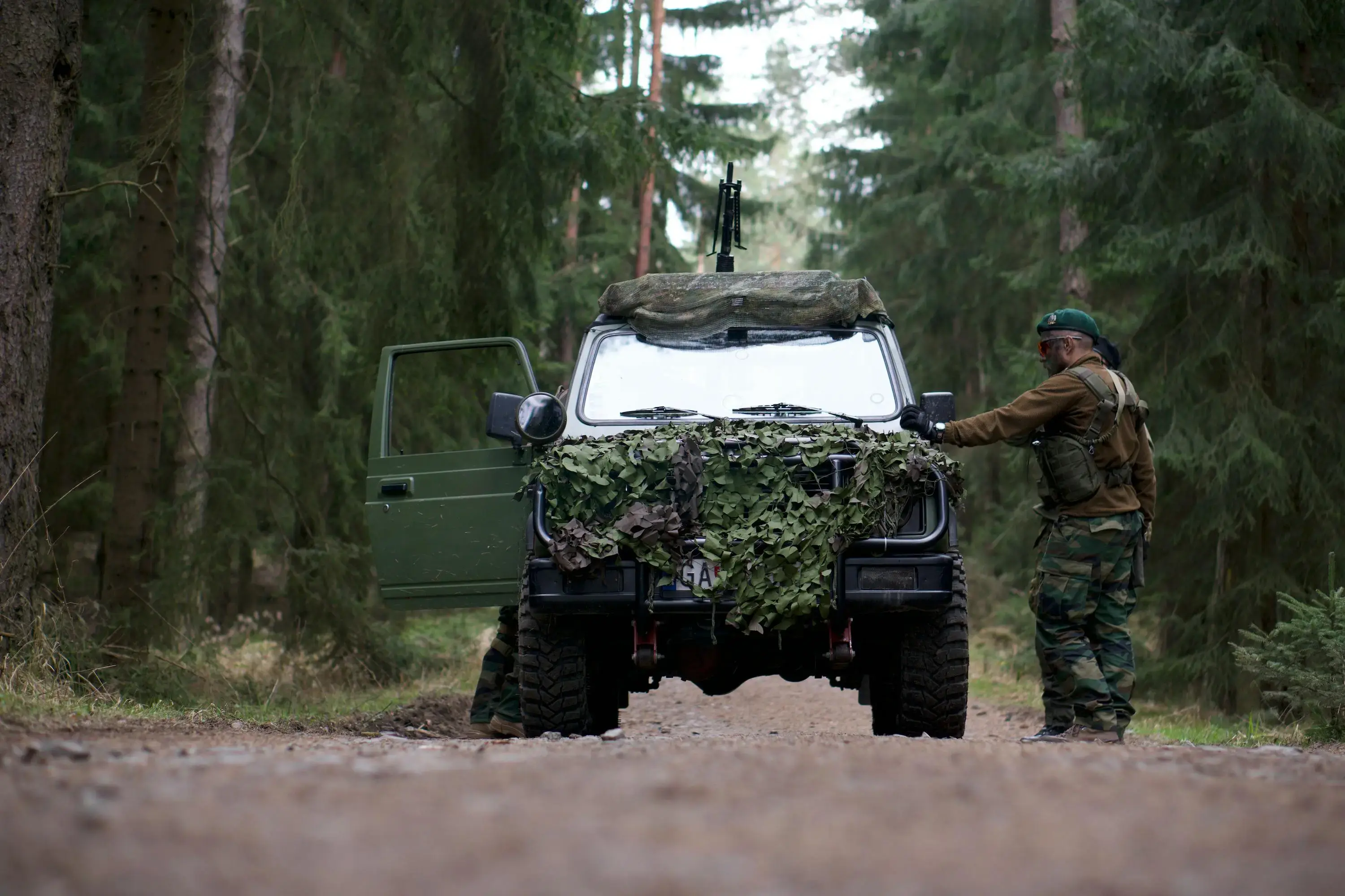 Army Official Standing Beside Green Off road Car