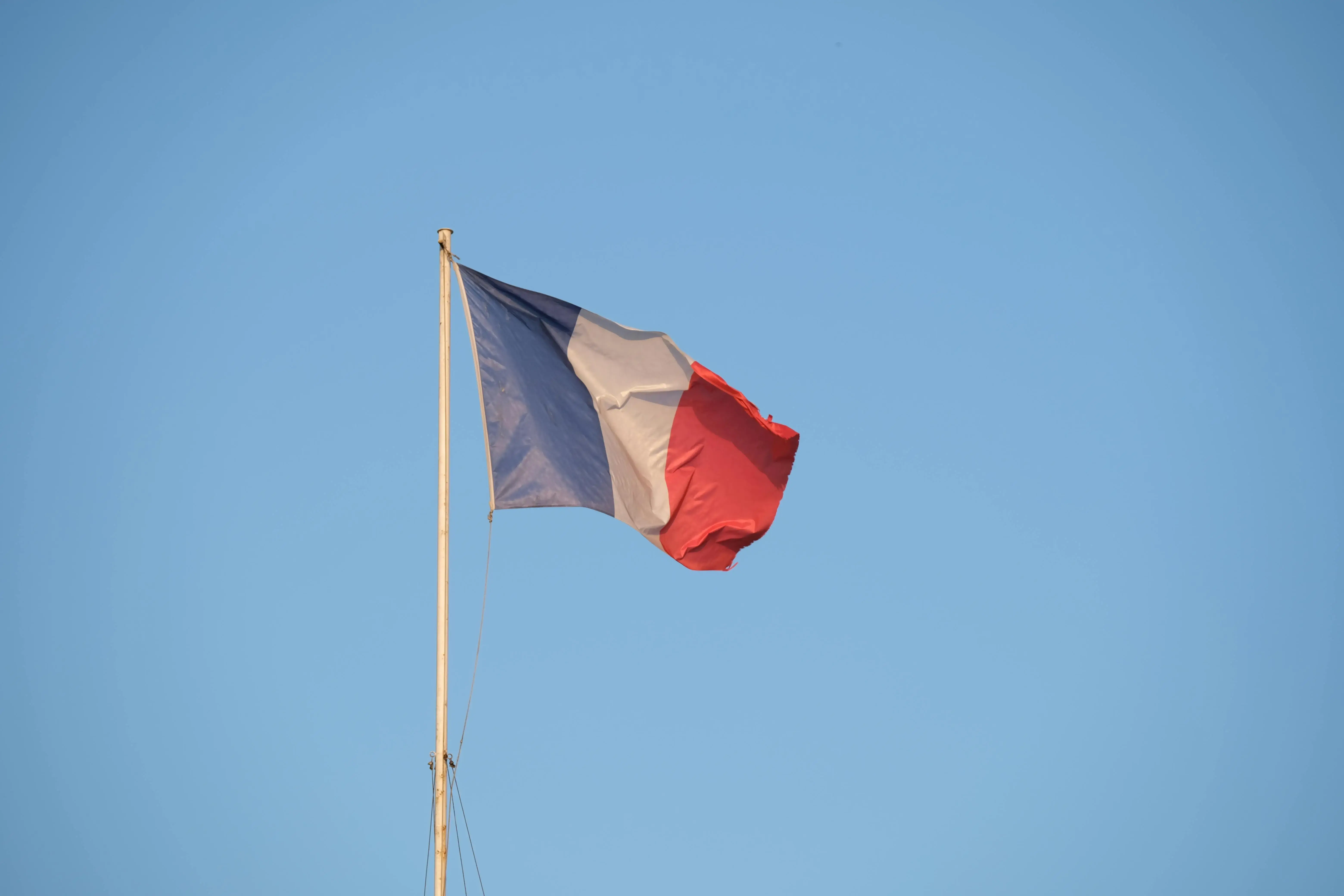 Close-up of the French Flag against a Clear, Blue Sky
