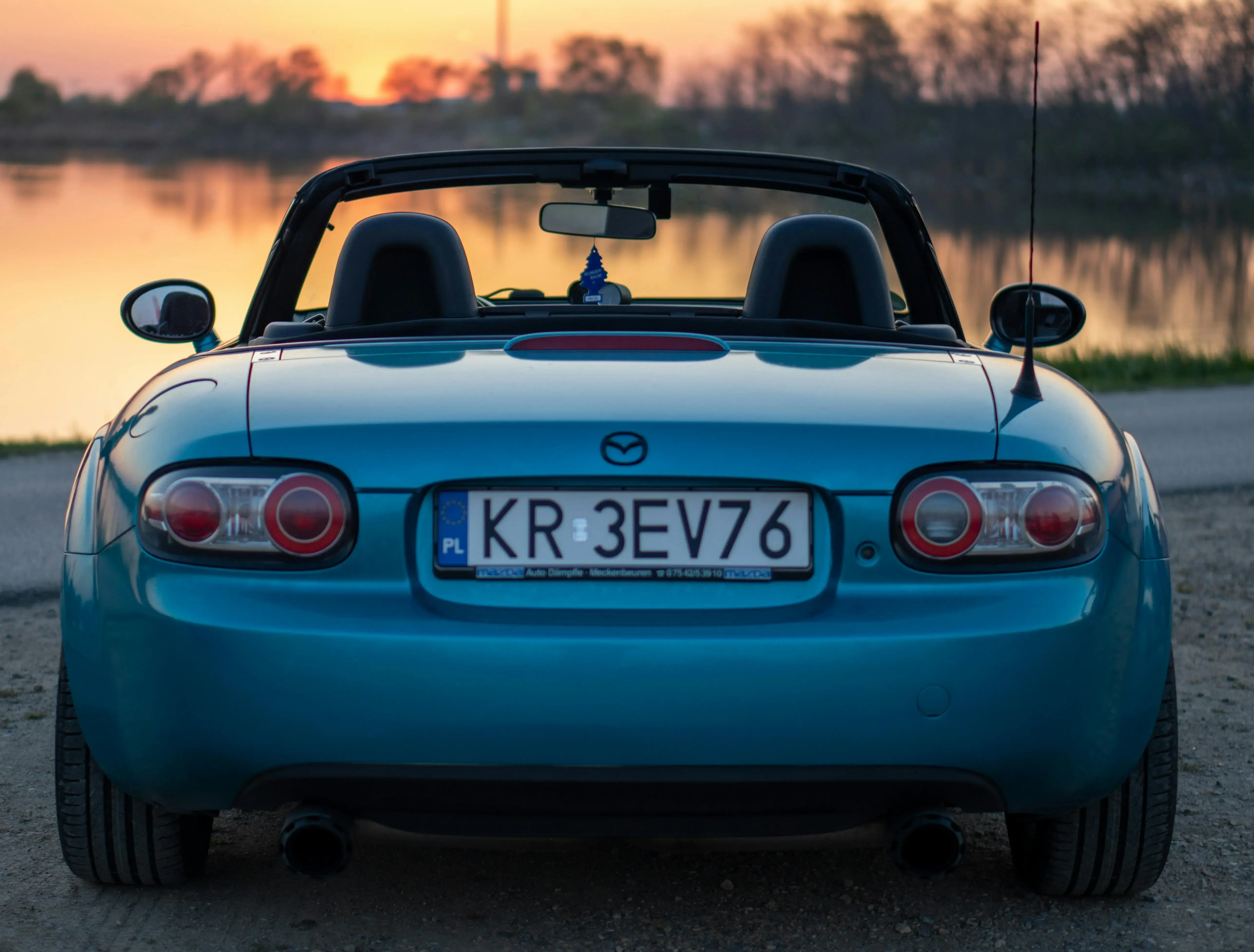Back of Blue Mazda MX-5 at Sunset