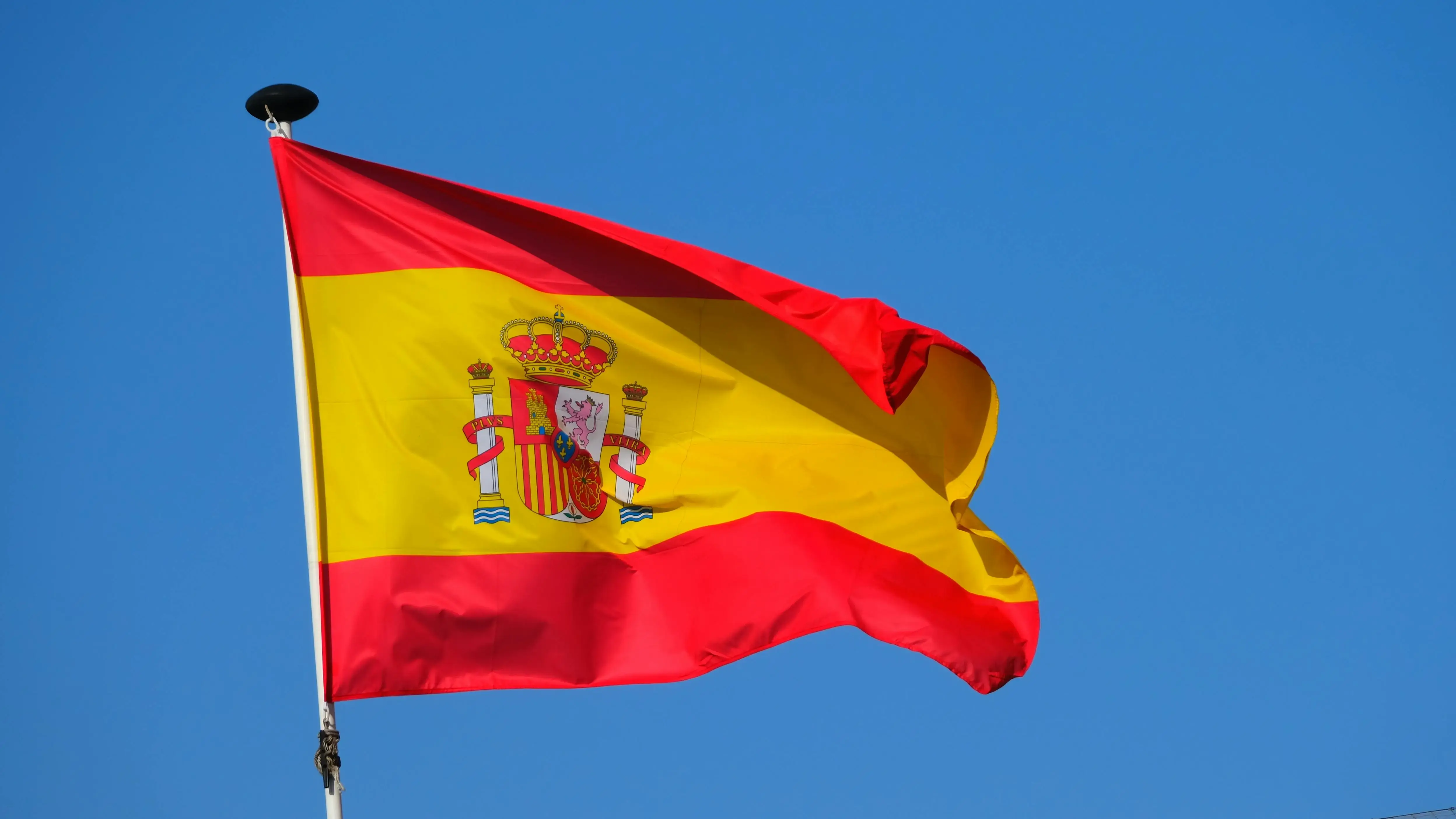 Flag of Spain under Blue Sky