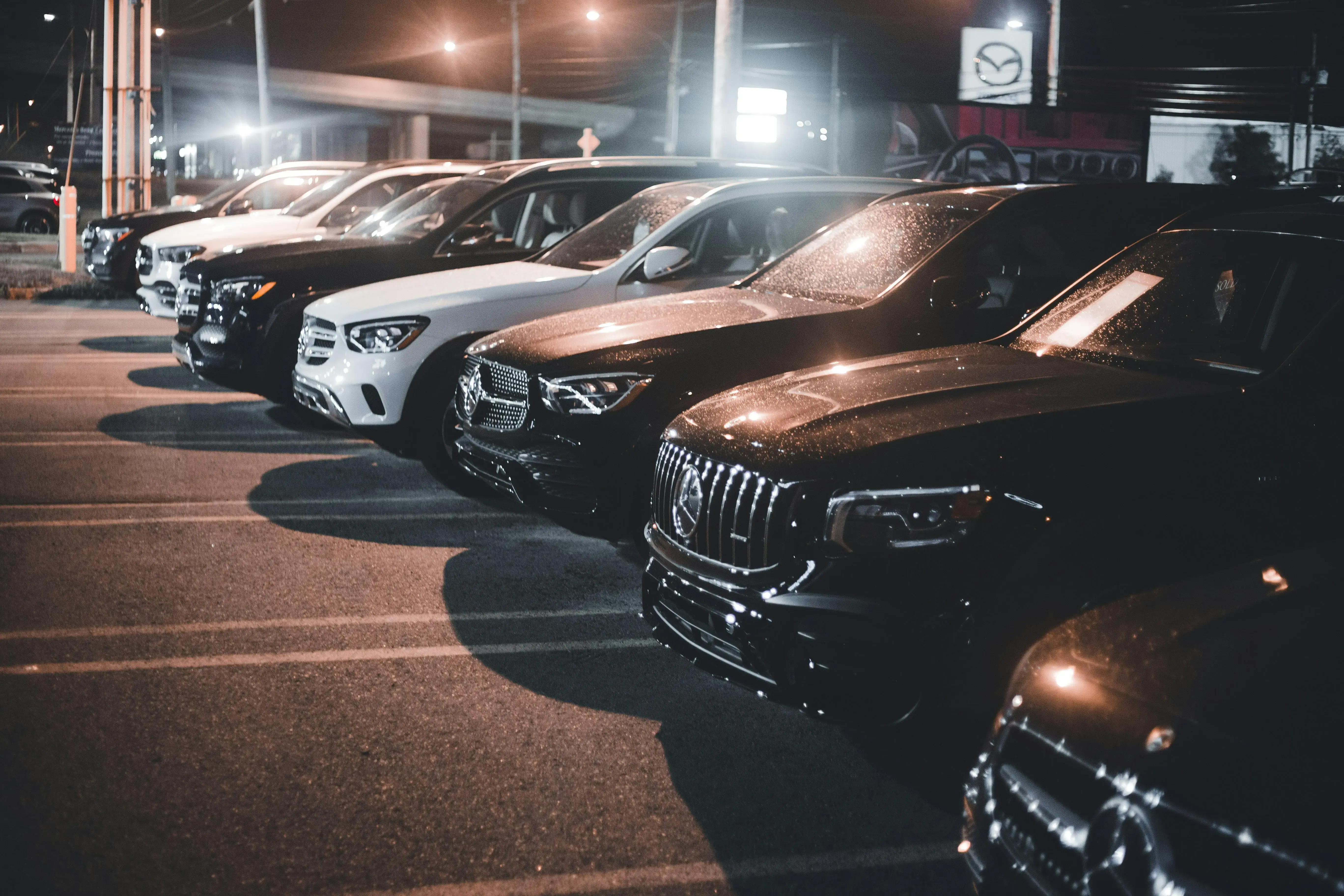 A Group of Luxury Cars Parked on a Parking Lot