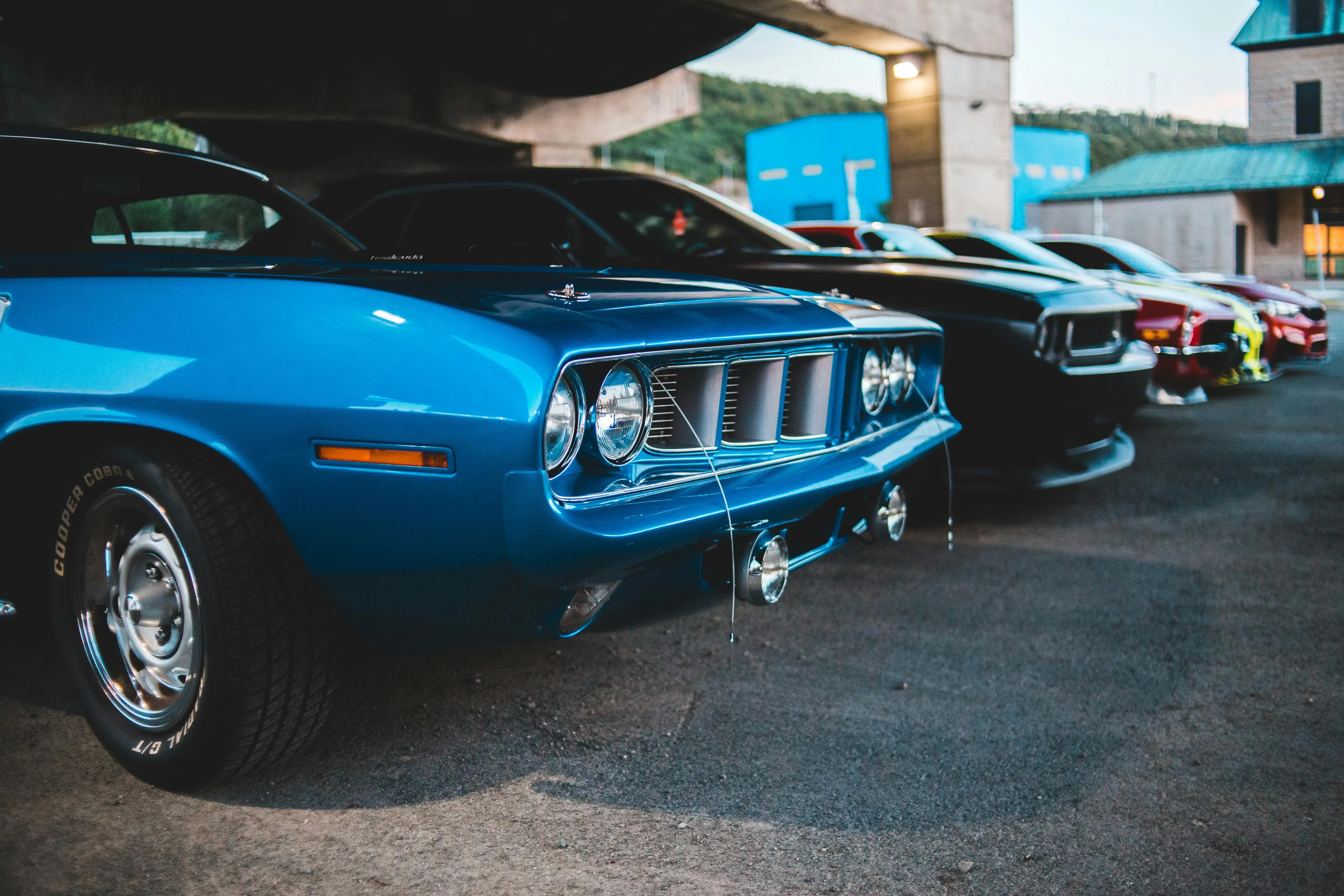 Different luxury cars parked near buildings