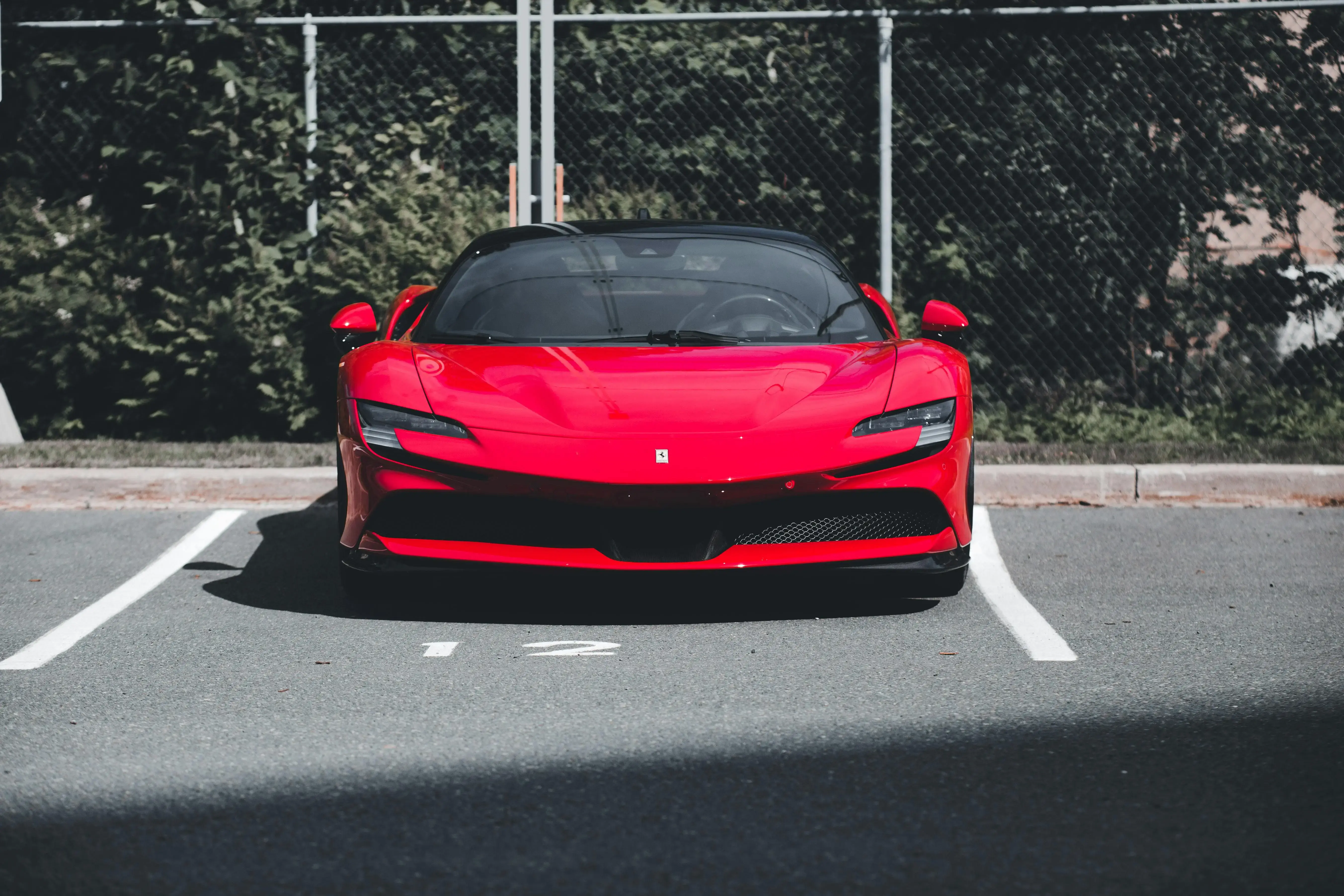 Shiny Red Ferrari at a Parking Lot