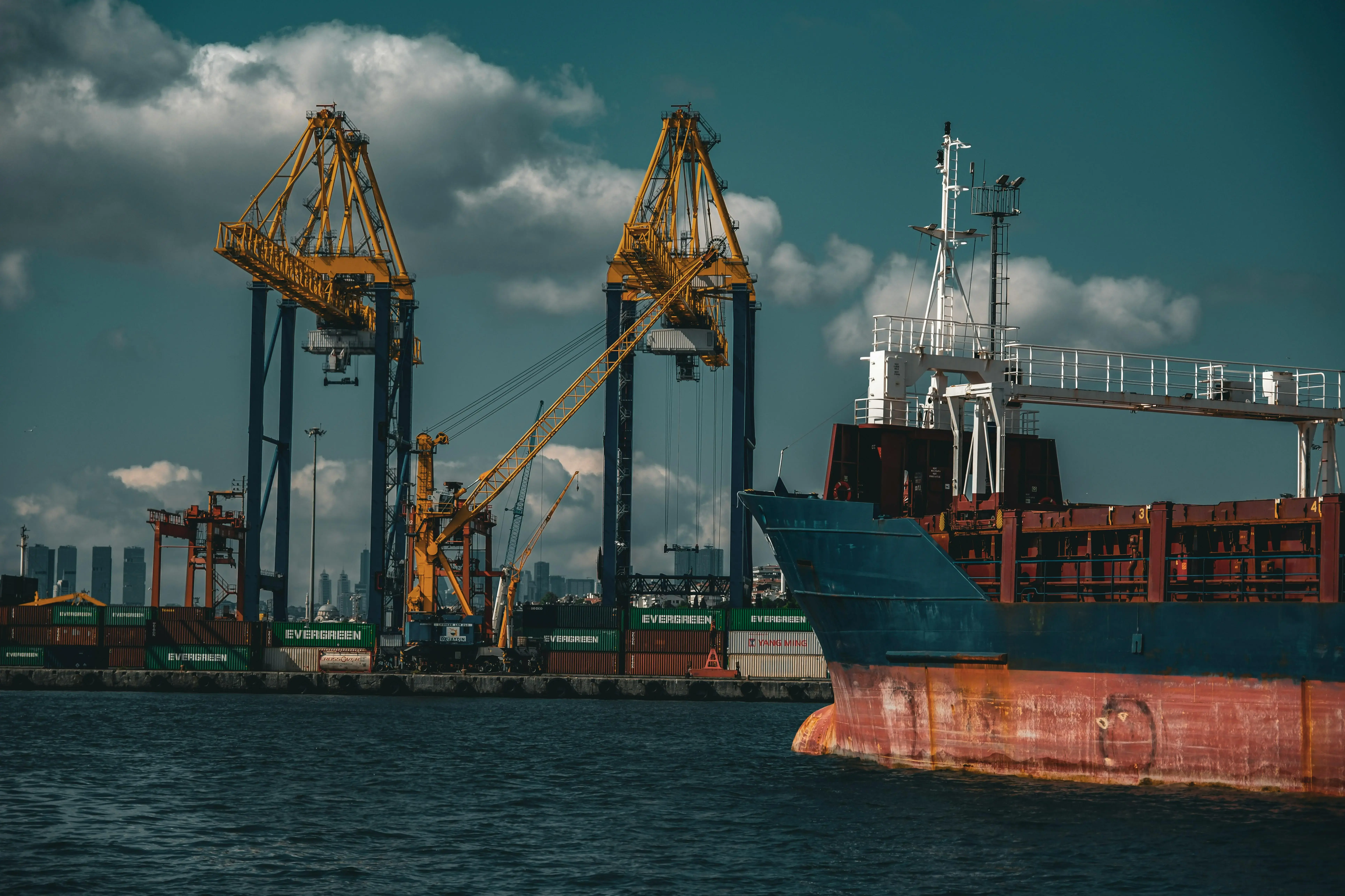 A large cargo ship is docked in a harbor