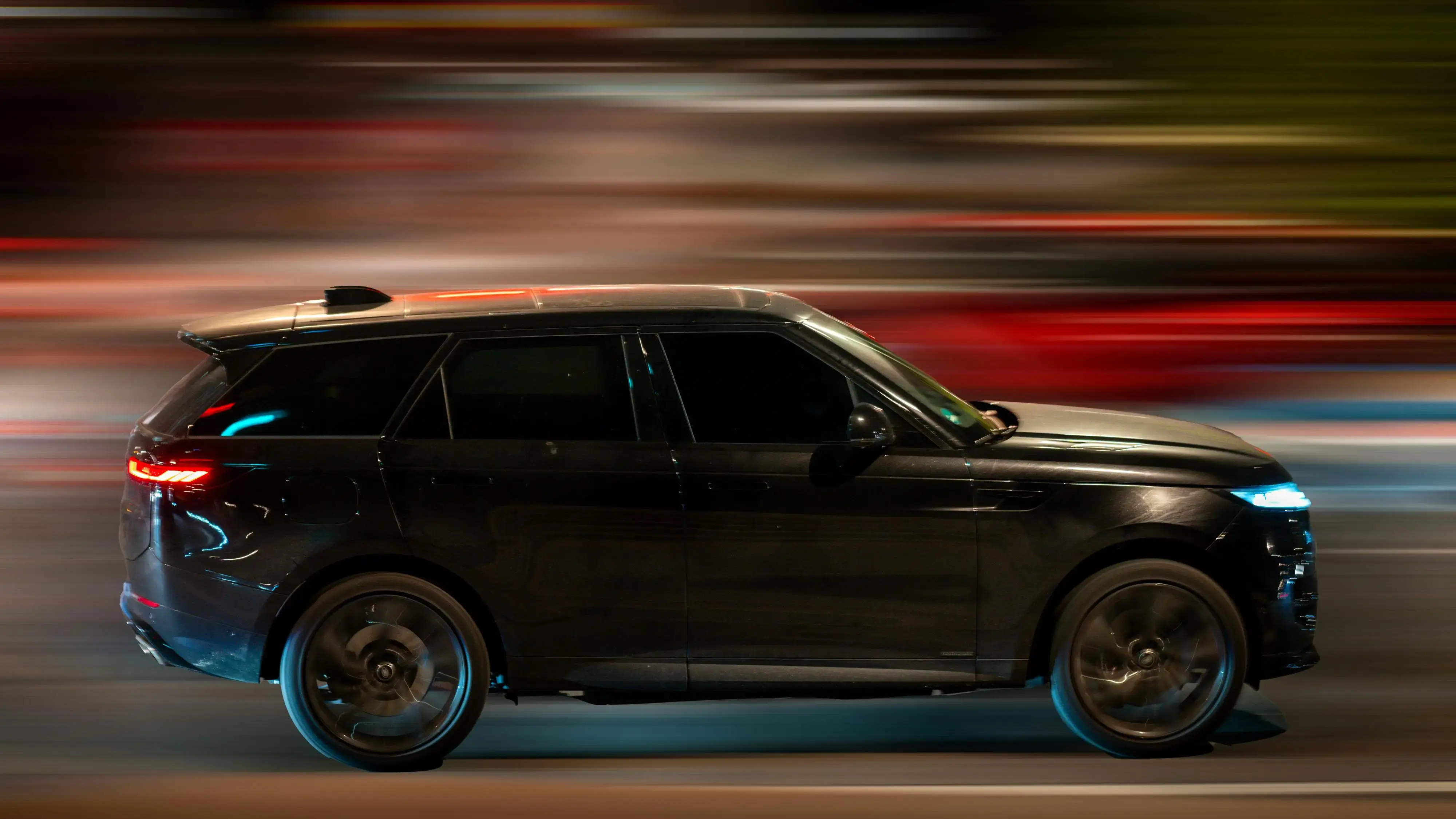 Elegant Black SUV In Motion At Night