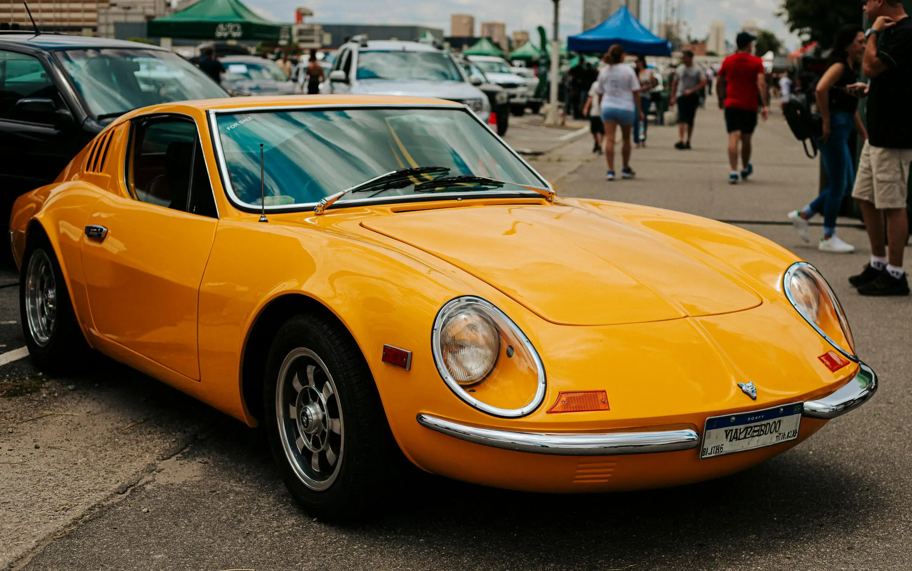 Vintage Yellow Sports Car at Outdoor Car Show