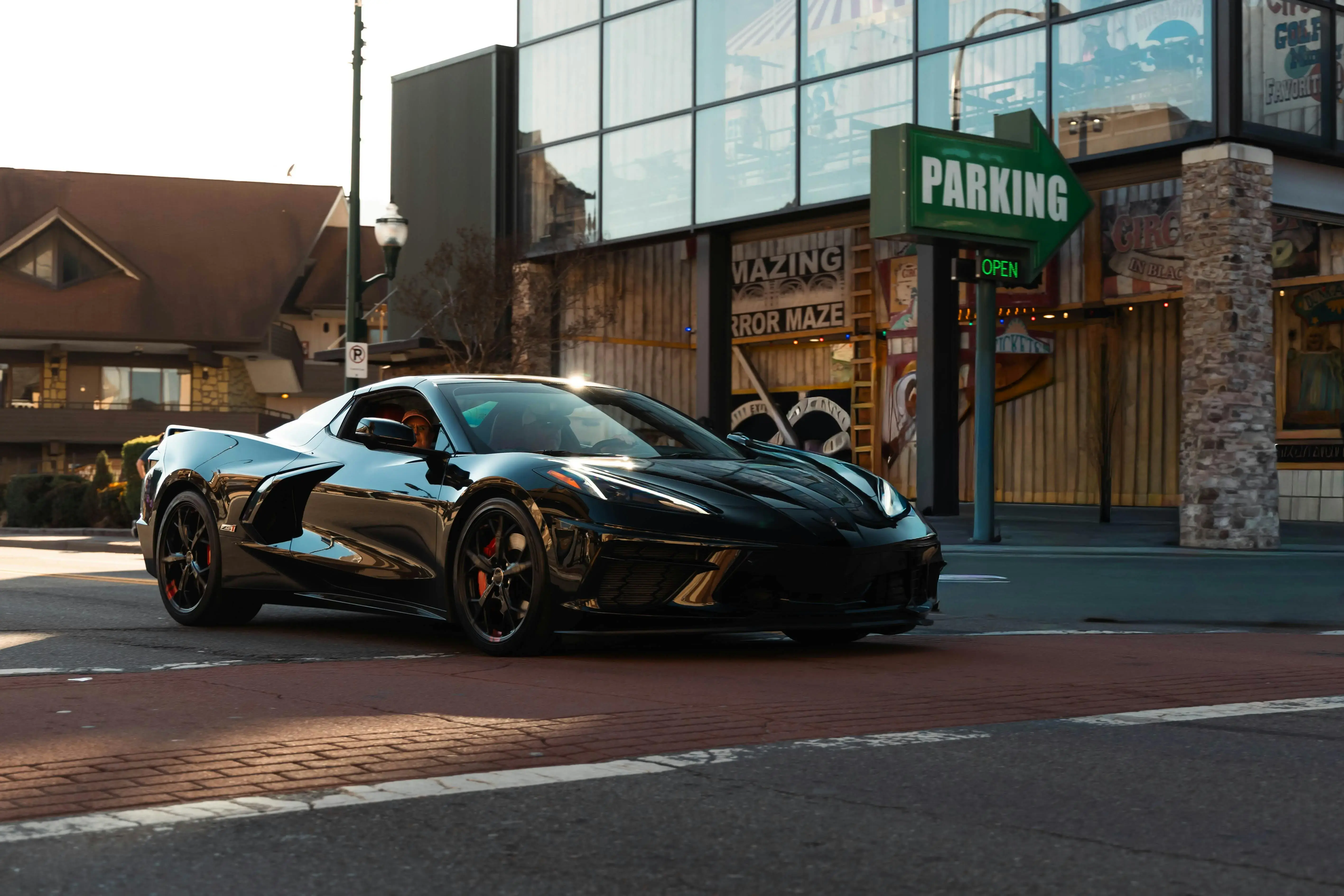 Sleek Black Sports Car at Urban Intersection