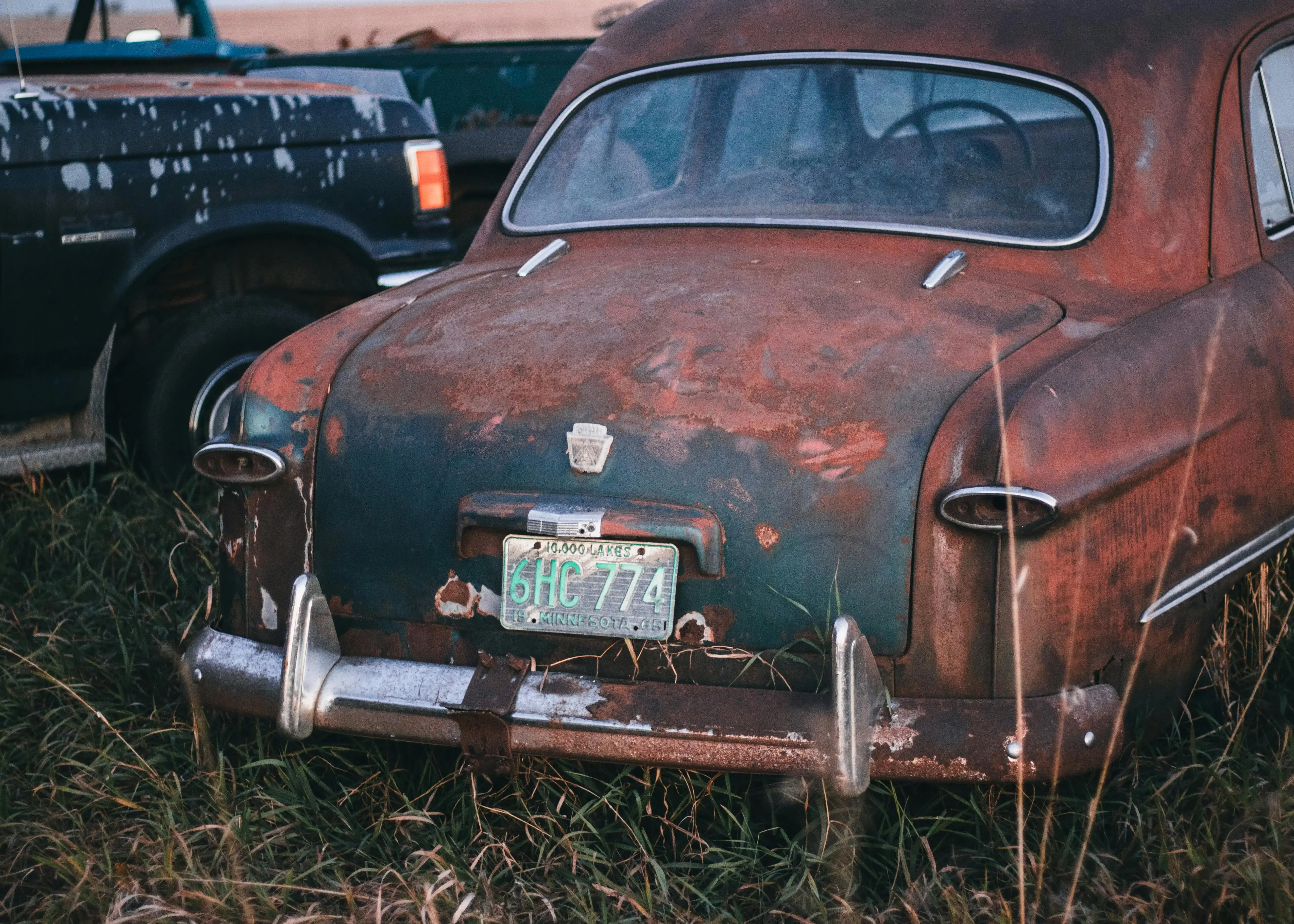 Rustic Vintage Car in Overgrown Field