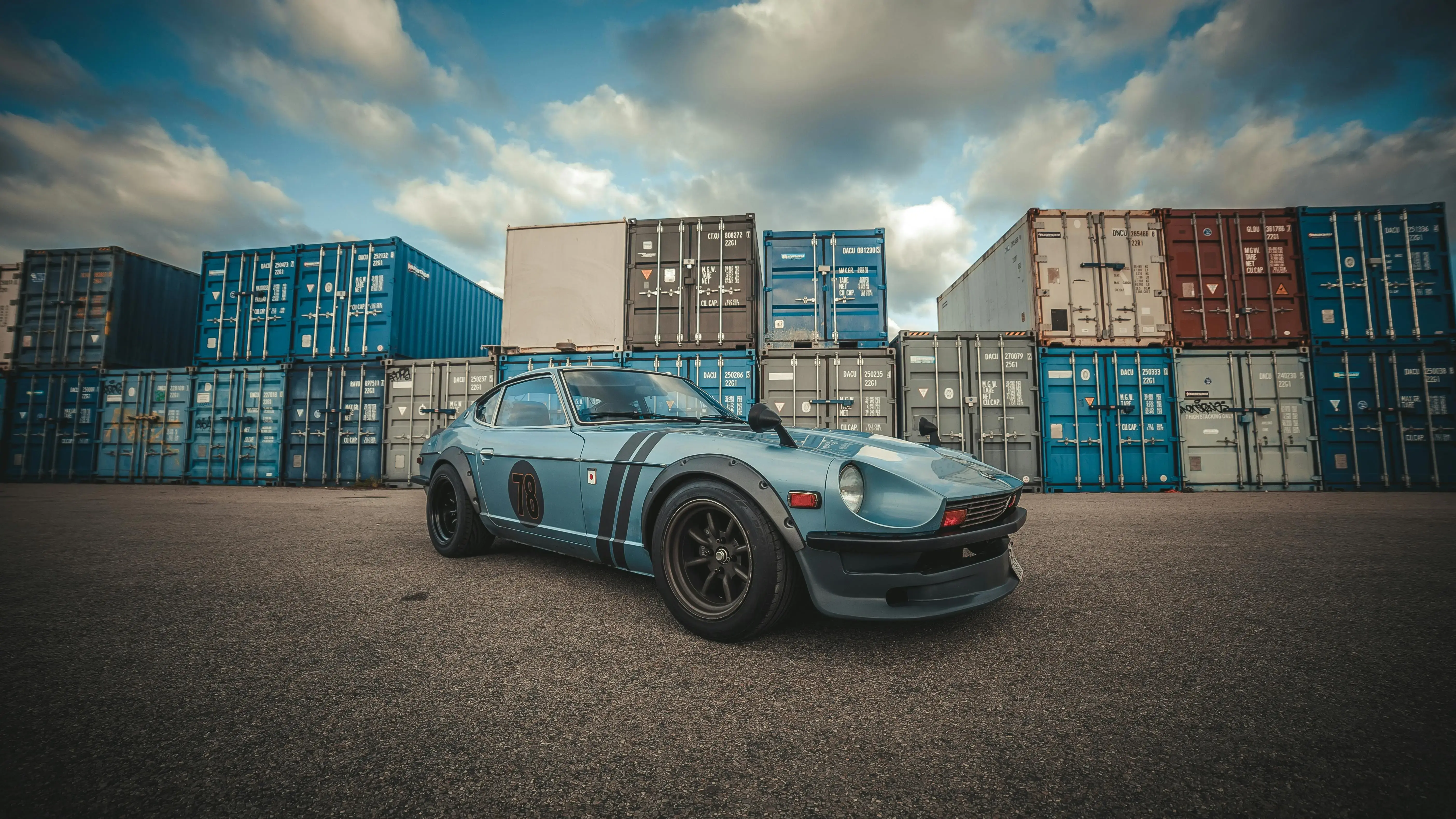 Datsun 280Z Parked on the Background of Containers in a Port
