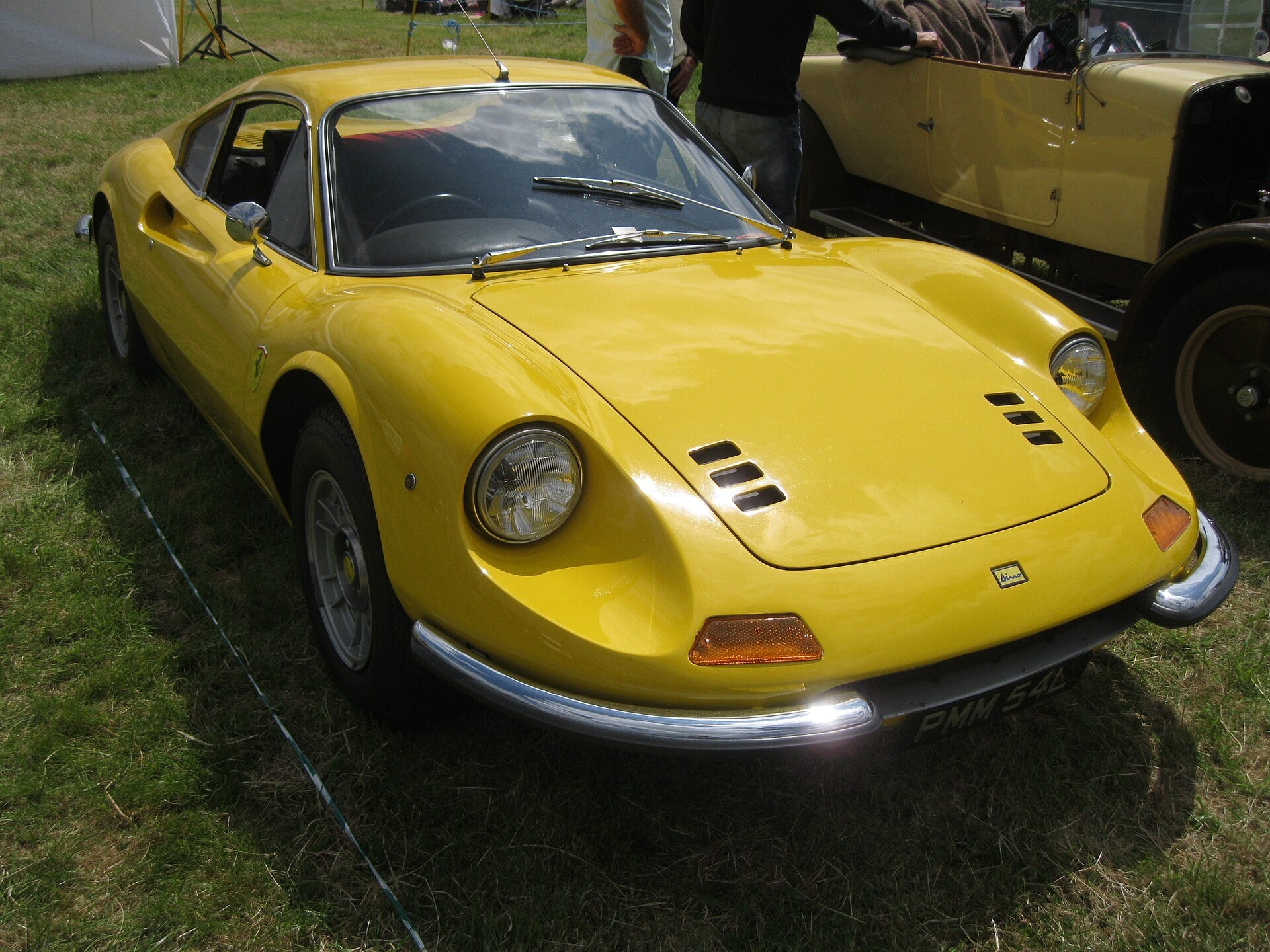Yellow Ferrari Dino 246 GT coupe on grass