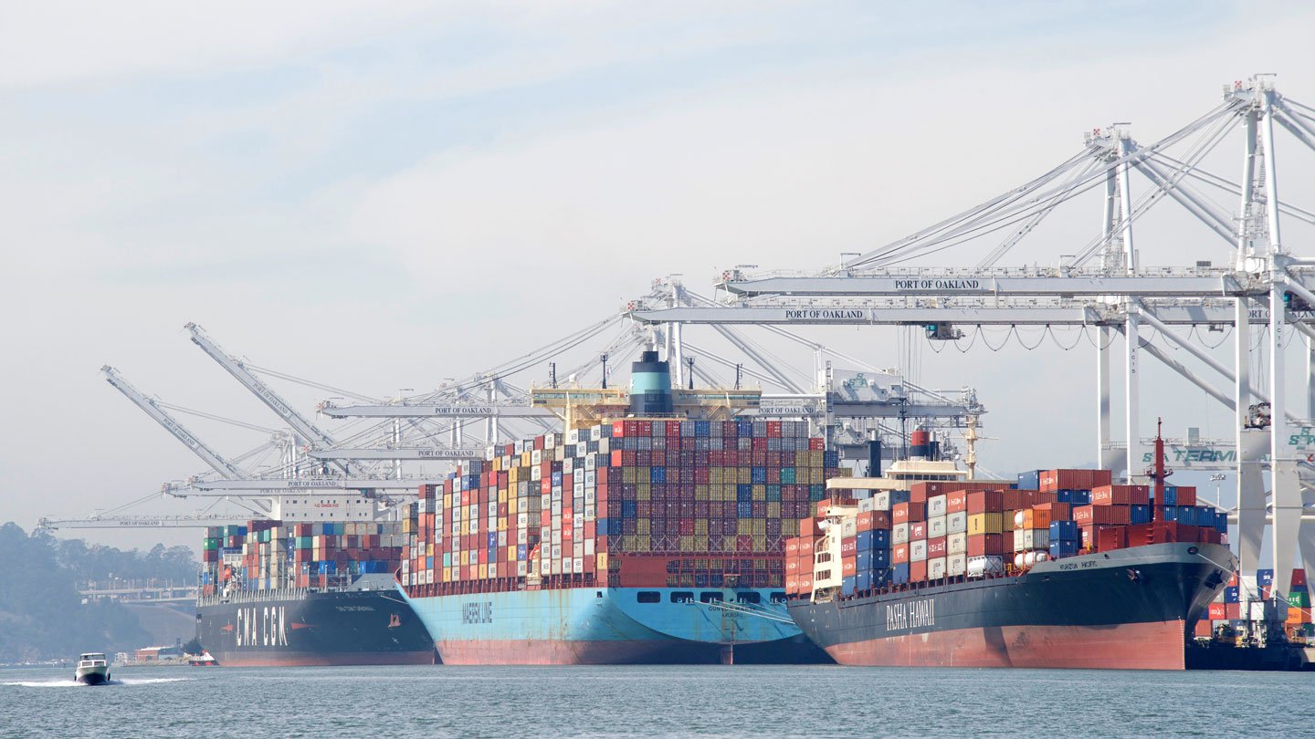 What is a transshipment and how does it affect transit times?