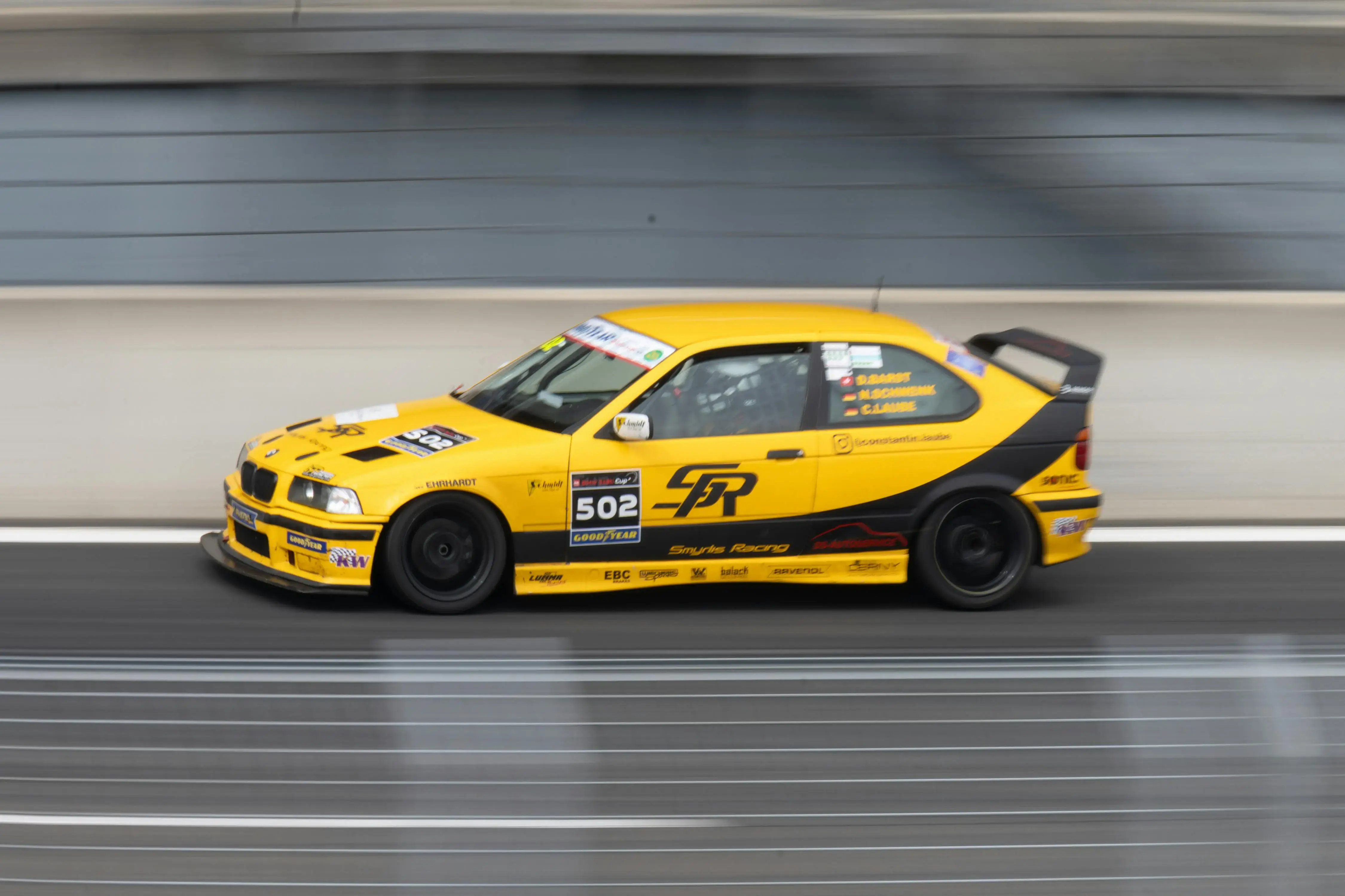 High-Speed Yellow Racing Car on Track