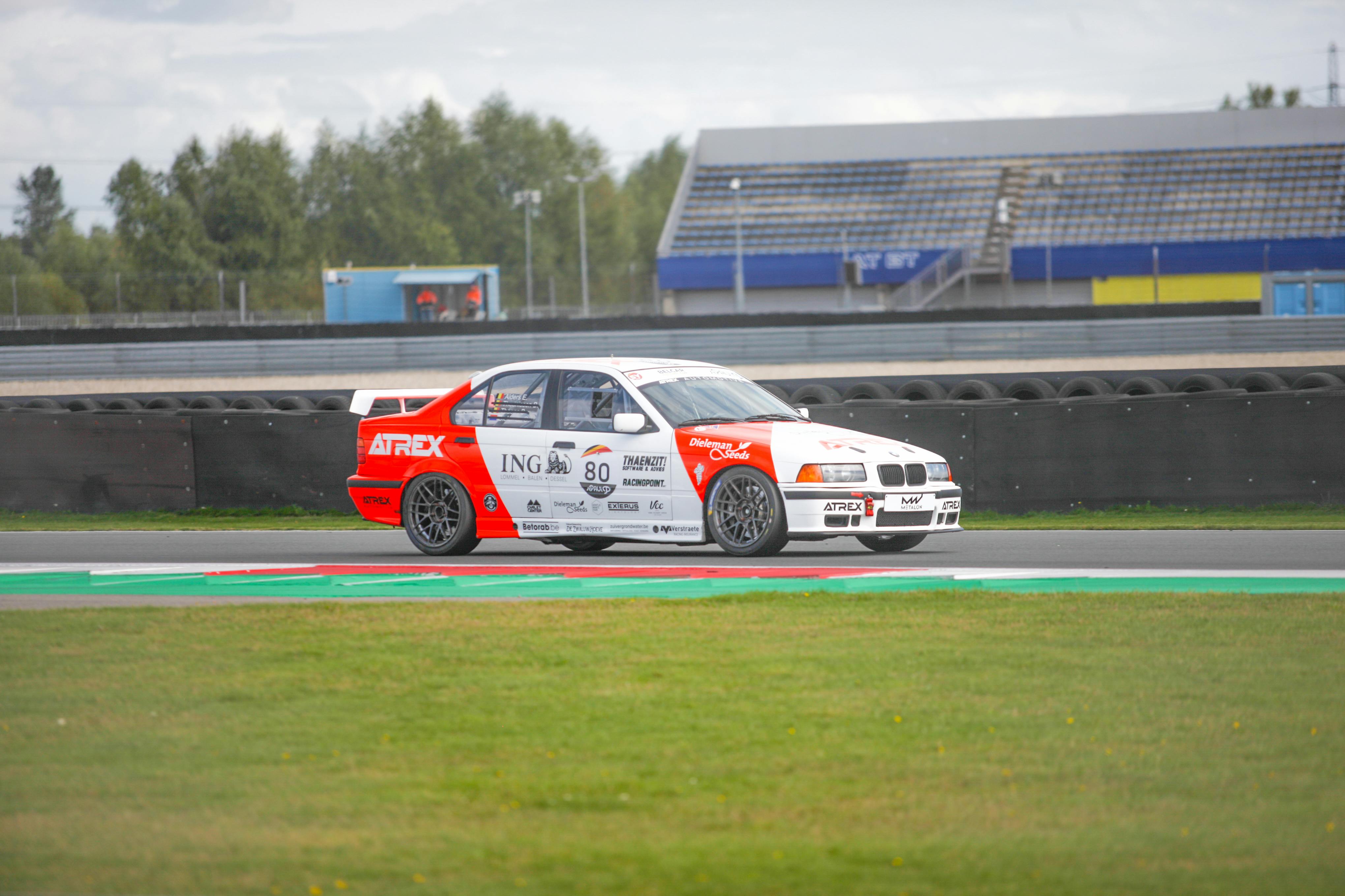 BMW Race Car on Track During Daytime Event