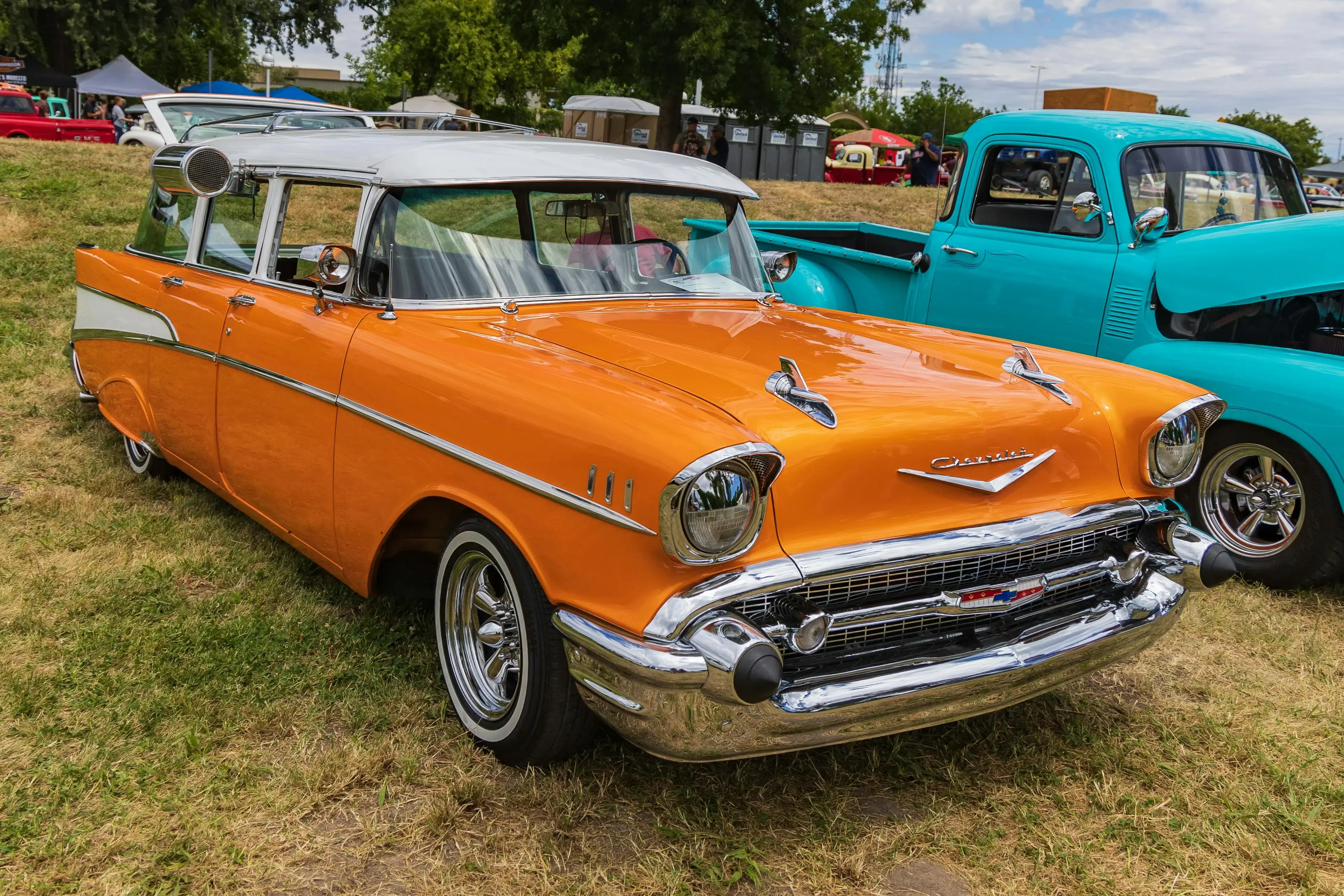 An Orange Chevrolet Bel Air Parked on Grass